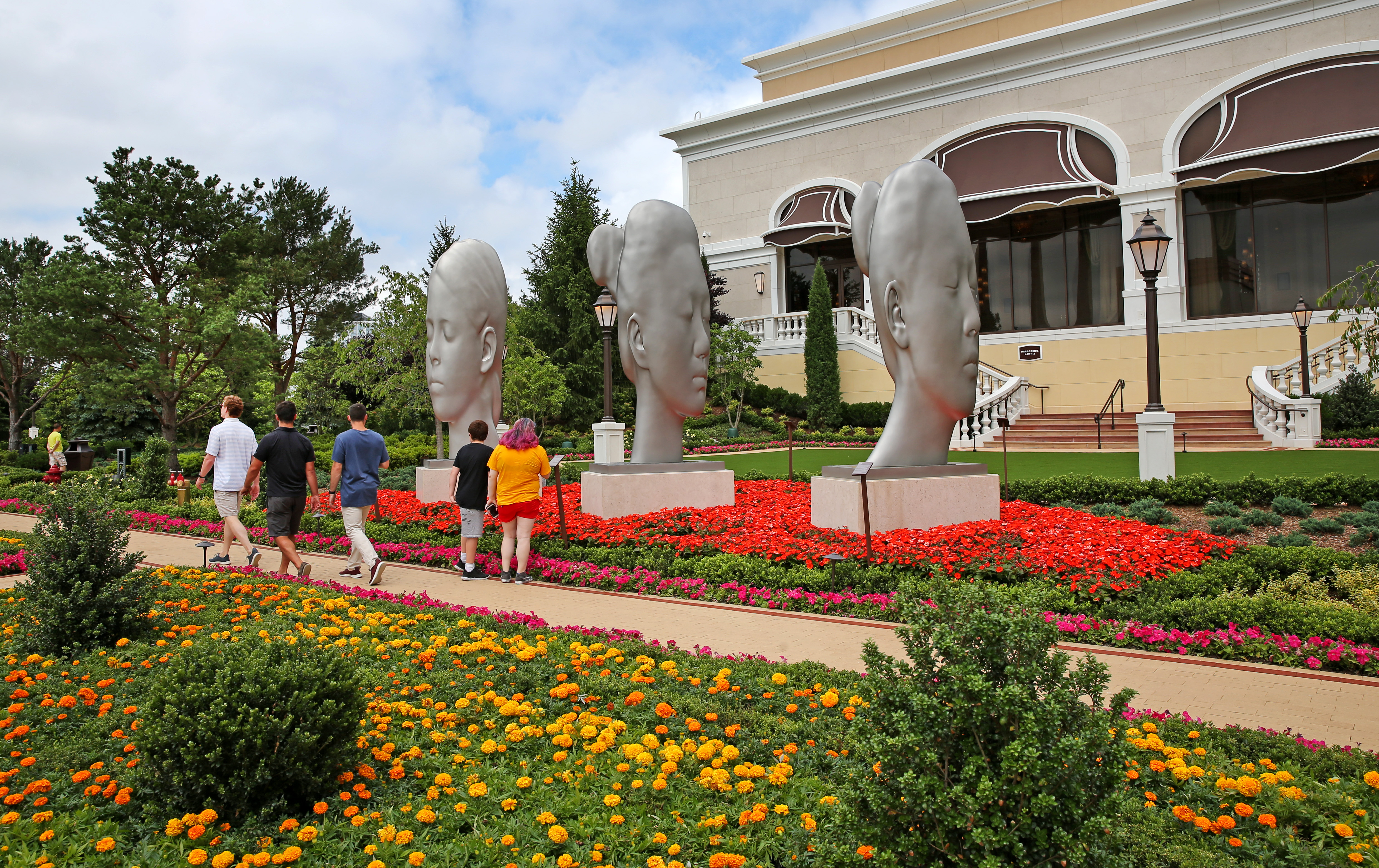 Brilliant floral beds formed a carpet around a trio of sculptures.