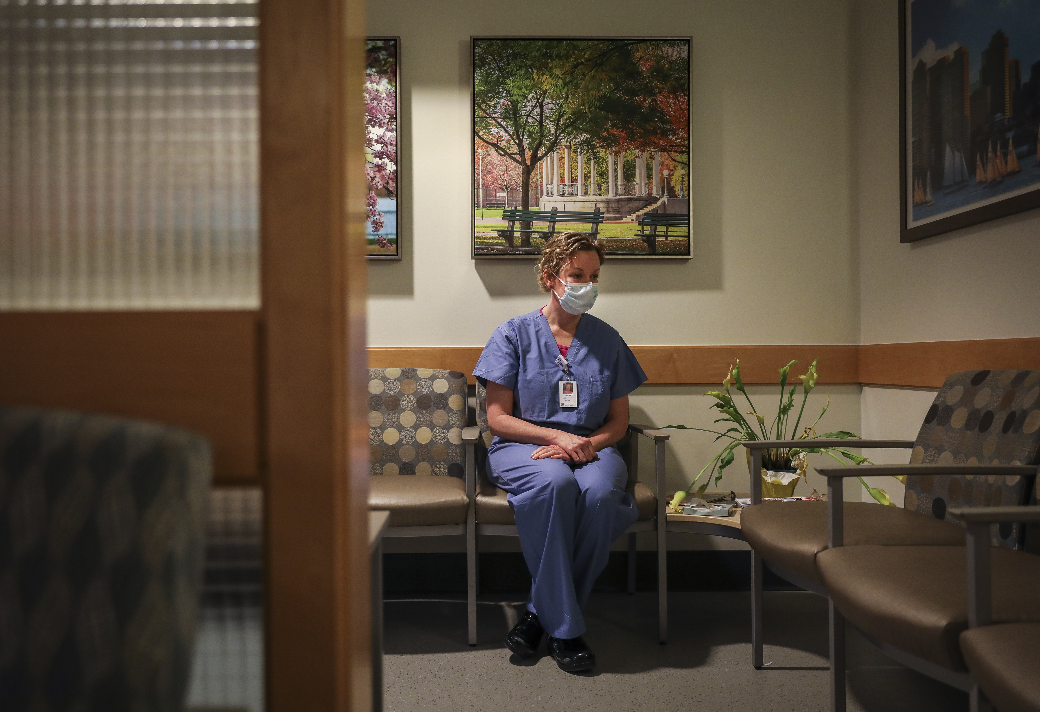 Christine McCarthy sat for a portrait in what is usually a full waiting room in the ICU at Massachusetts General Hospital. McCarthy has worked as a nurse at MGH for over 20 years and has been a palliative nurse for the past year. (Erin Clark/Globe Staff)