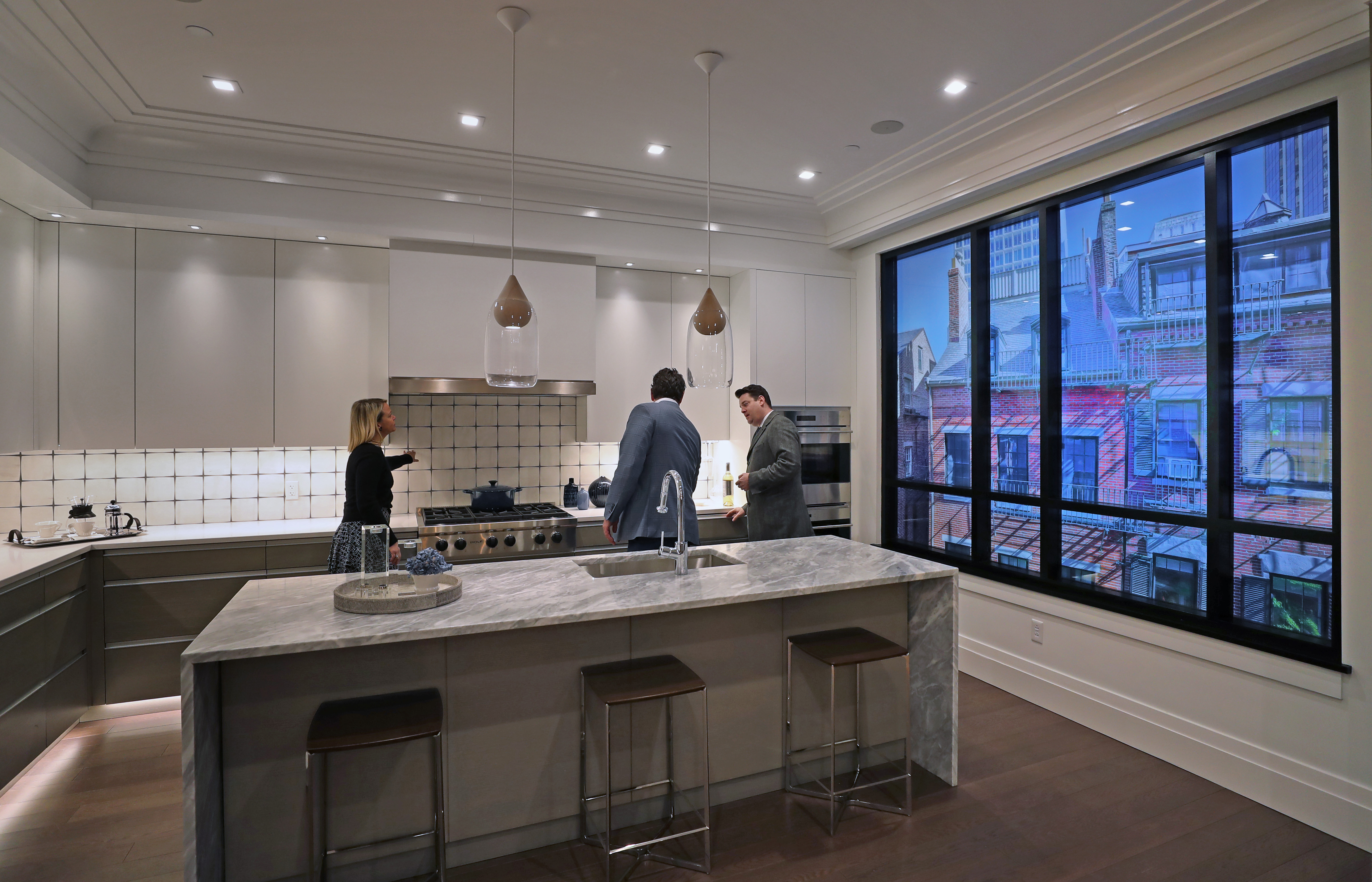 The kitchen mock-up at The Archer Residences, Beacon Hill, has a sample view on the windows to help prospective buyers imagine their living spaces.