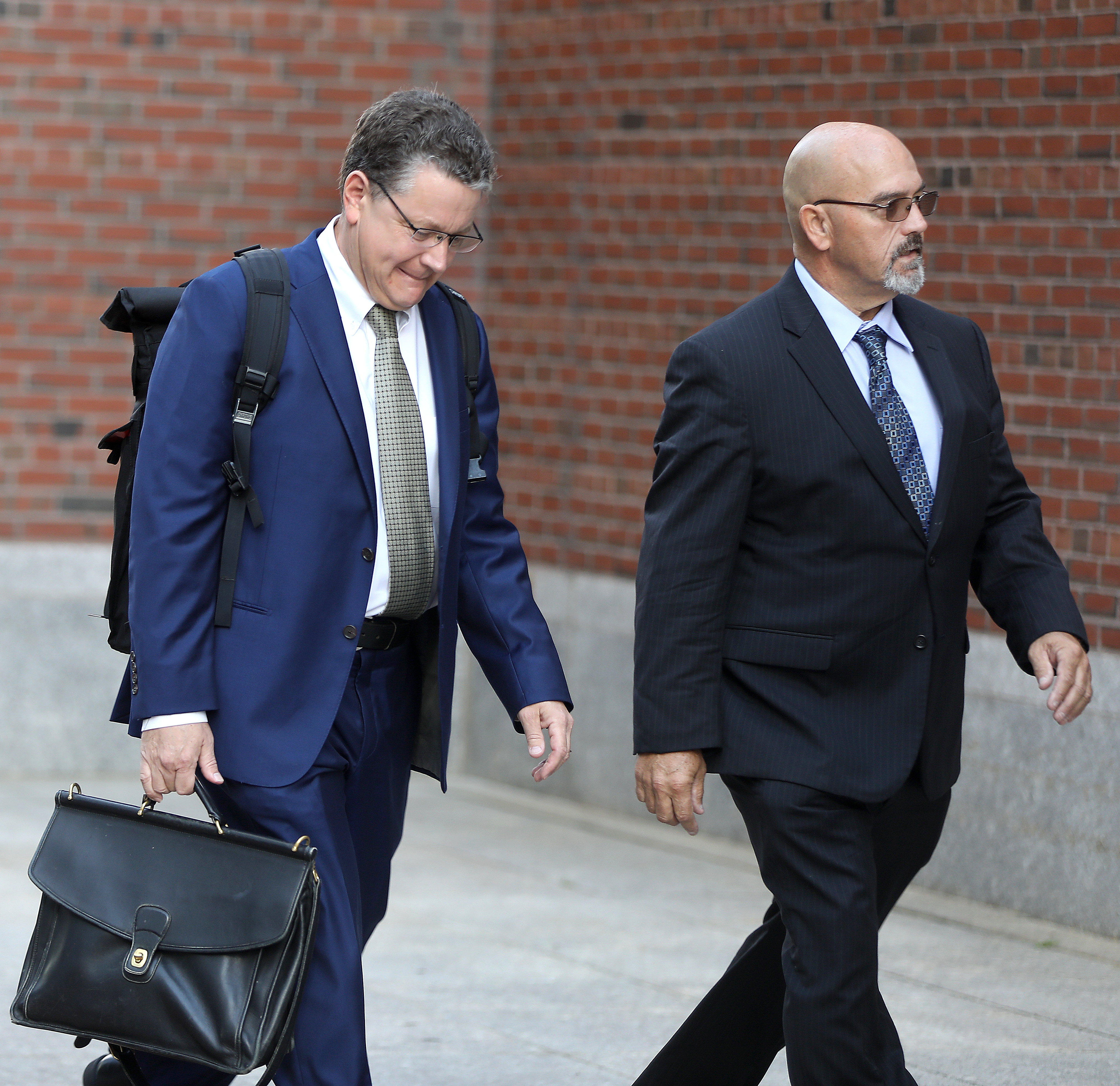Attorney Kevin Barron (left) walked with his client, Michael Ross.