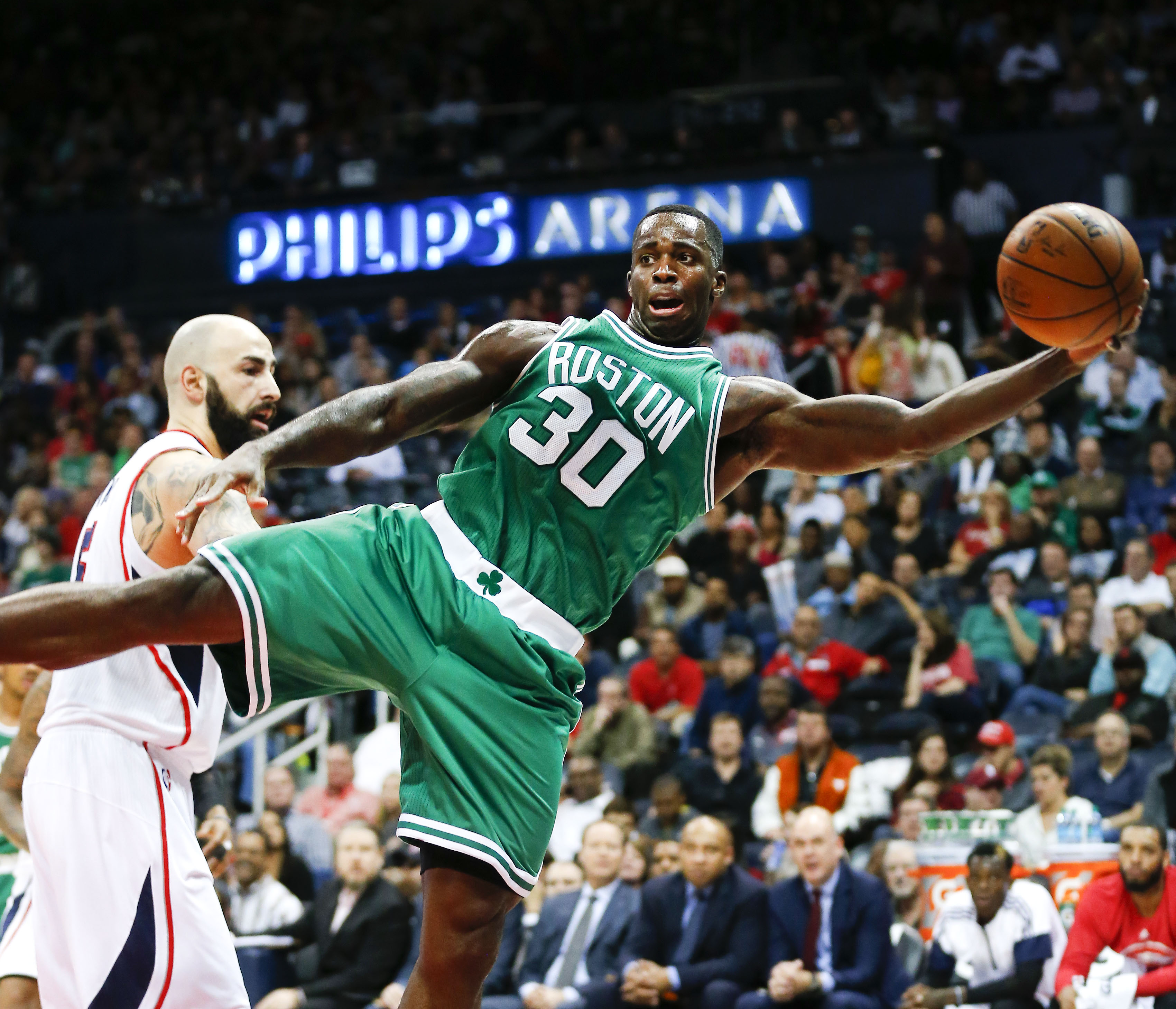The Celtics’ Brandon Bass was stretched to the limit in trying to keep this first-half possession alive.