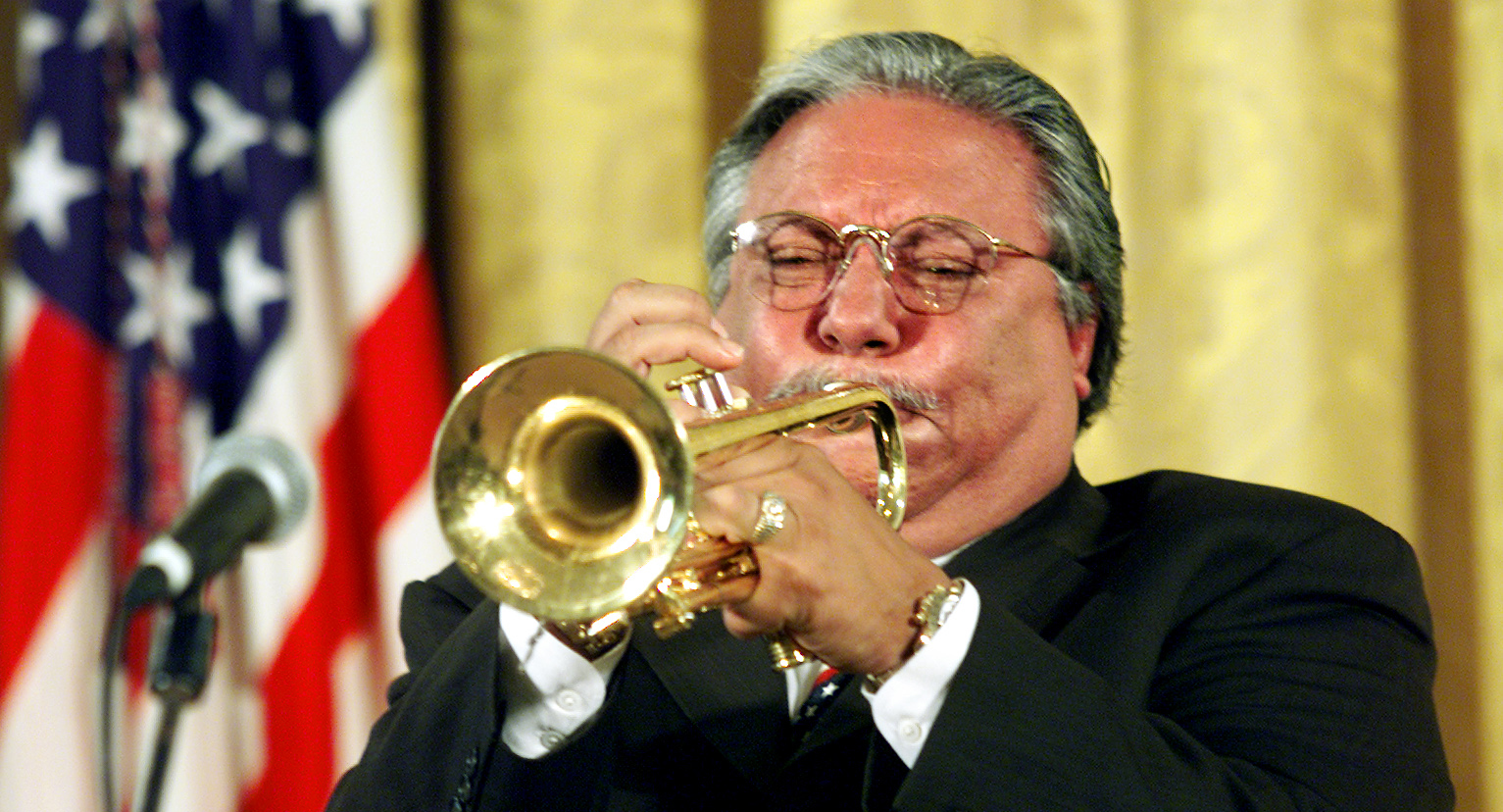 Cuban-born trumpeter Arturo Sandoval hits the final high note of "America The Beautiful" while playing at the White House in 2001.