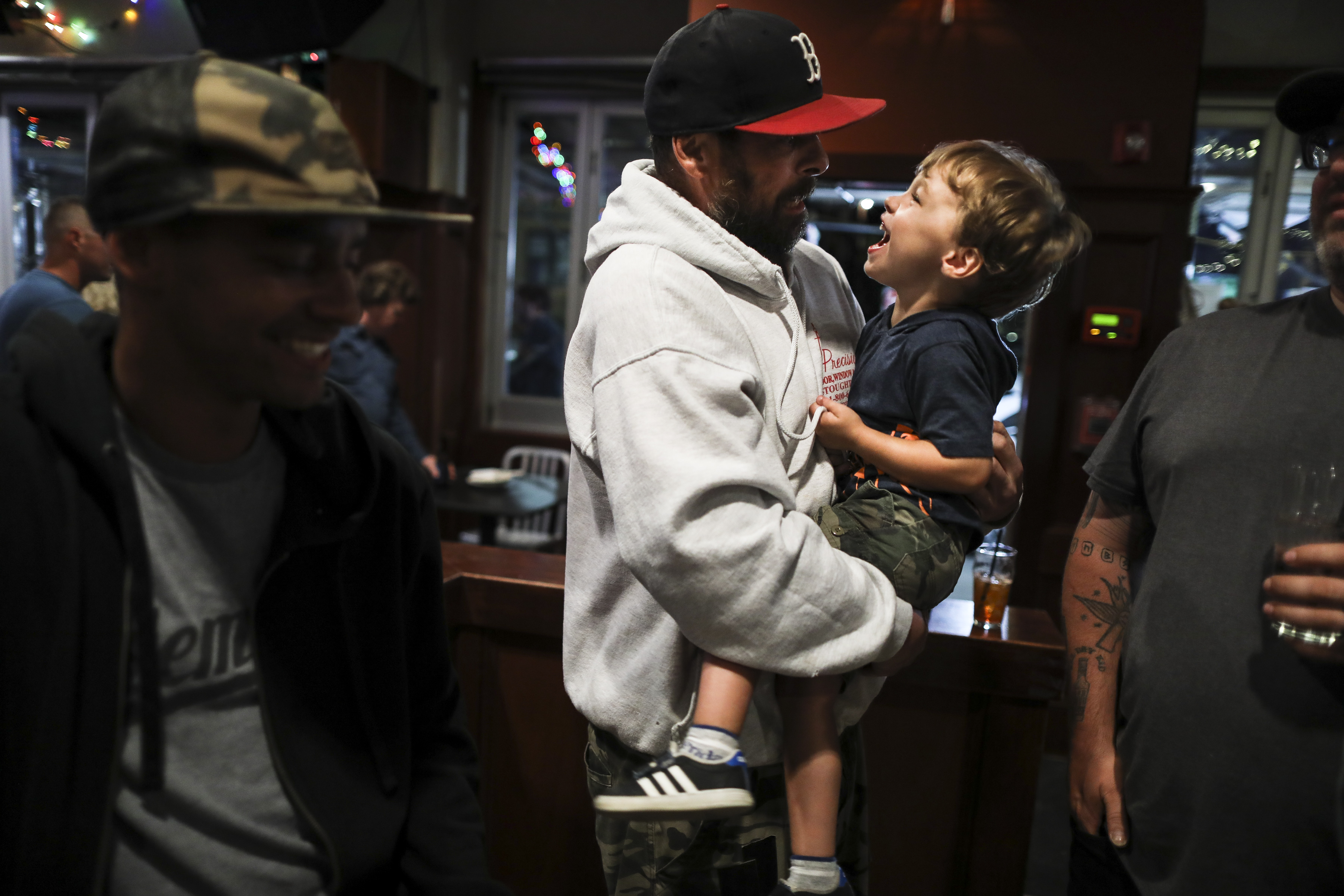 Joey Robicheau held Arthur Buckley, 3, on Sunday, the last night Common Ground was open.