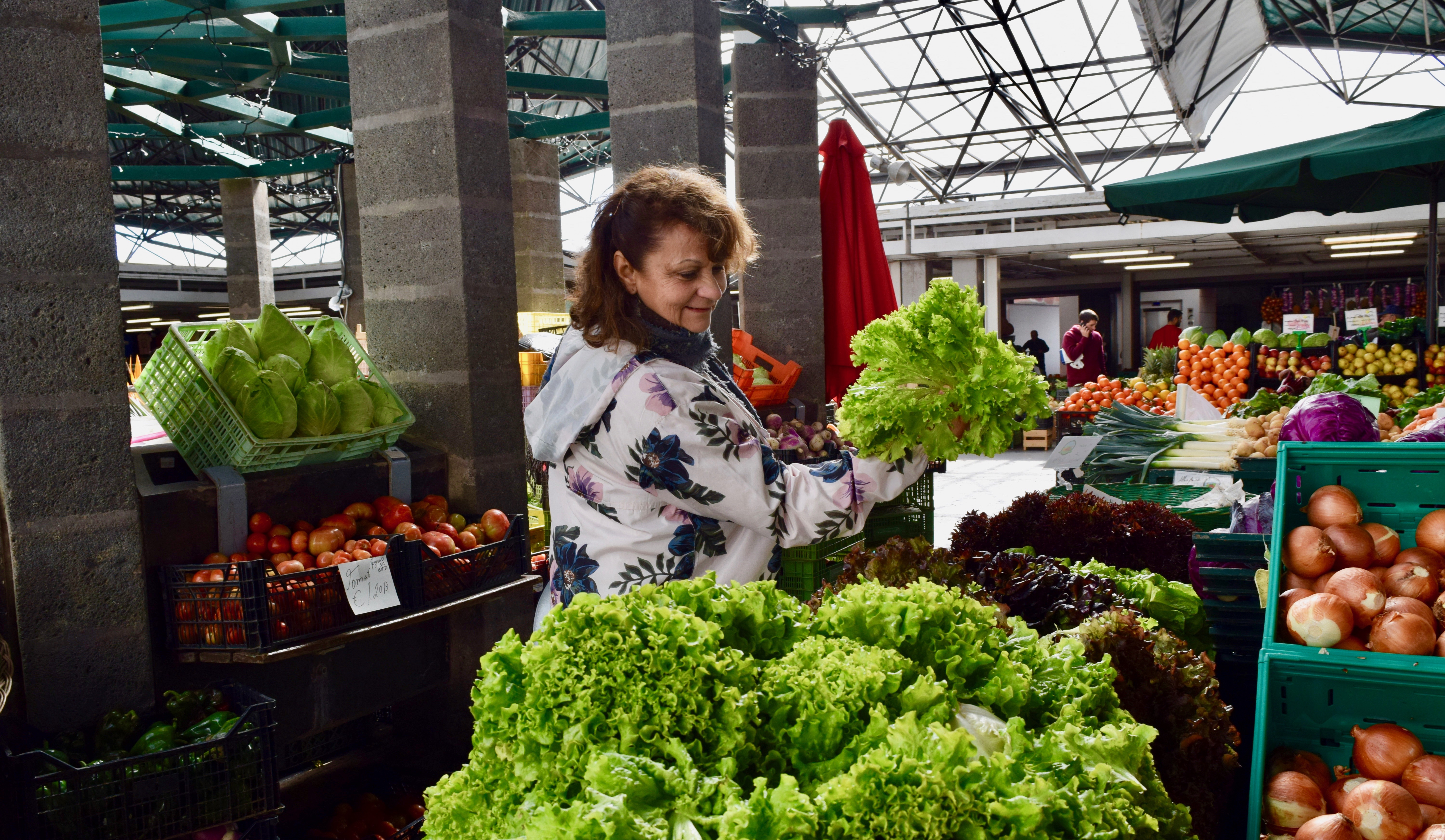 Guida Ponte, who leads food tours on the Azores inspects the produce at the farmers' market in Ponta Delgada on the island of São Miguel in the Azores