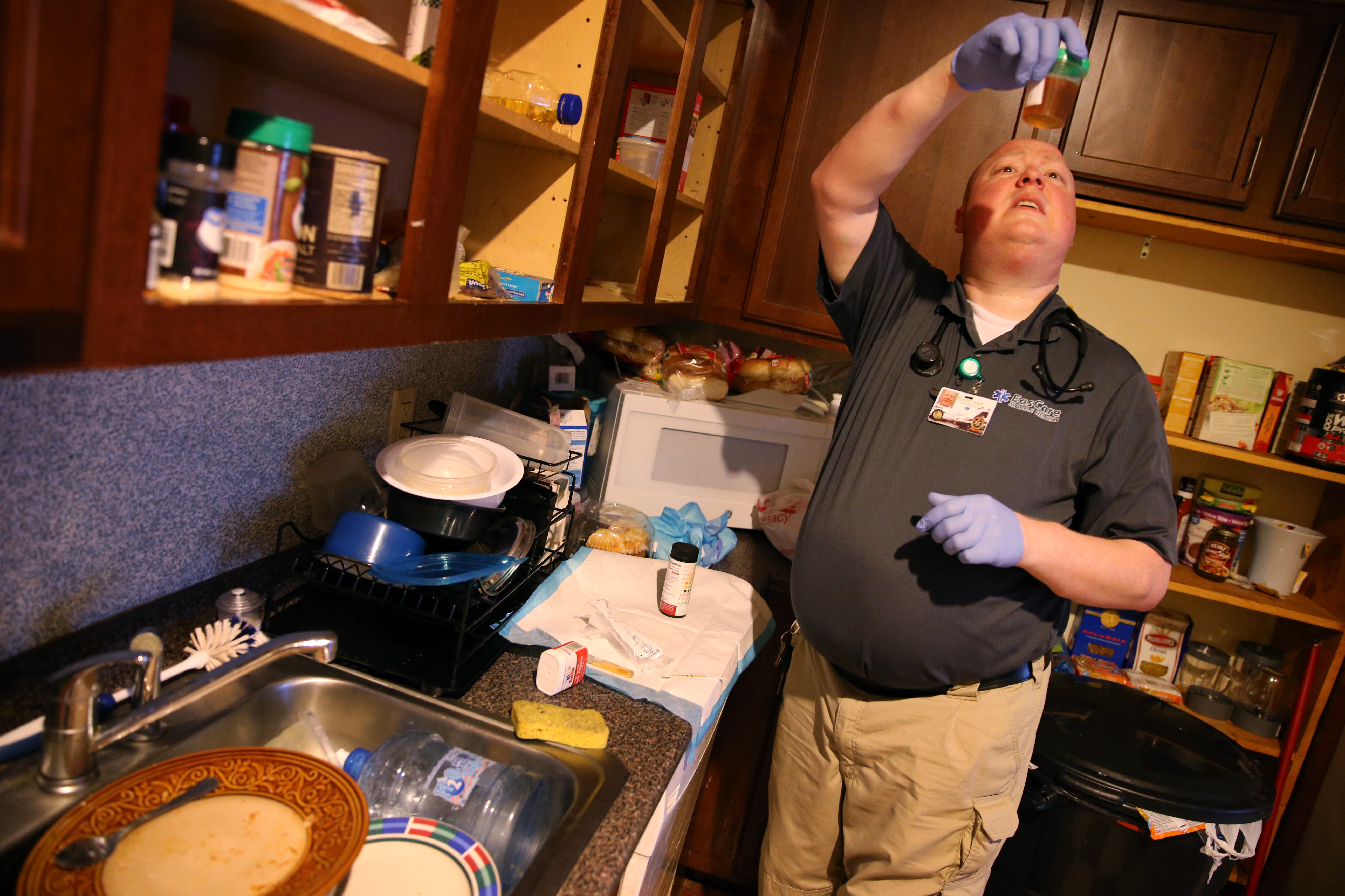 Paramedic Matthew Michaud examined a urine sample during a home visit.