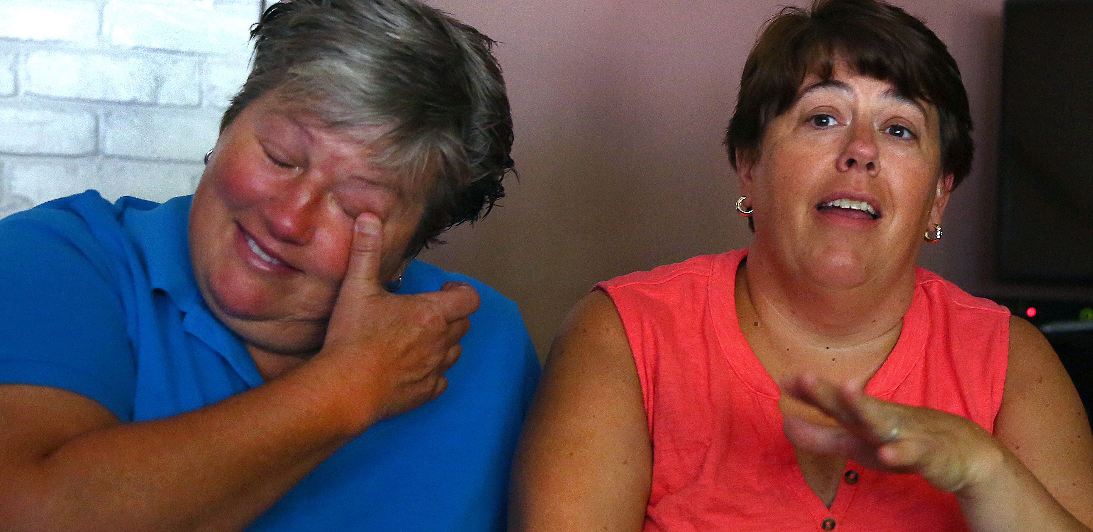 Lauri (left) and Cari Ryding returned from vacation and discovered their rainbow flag stolen and their house egged.
