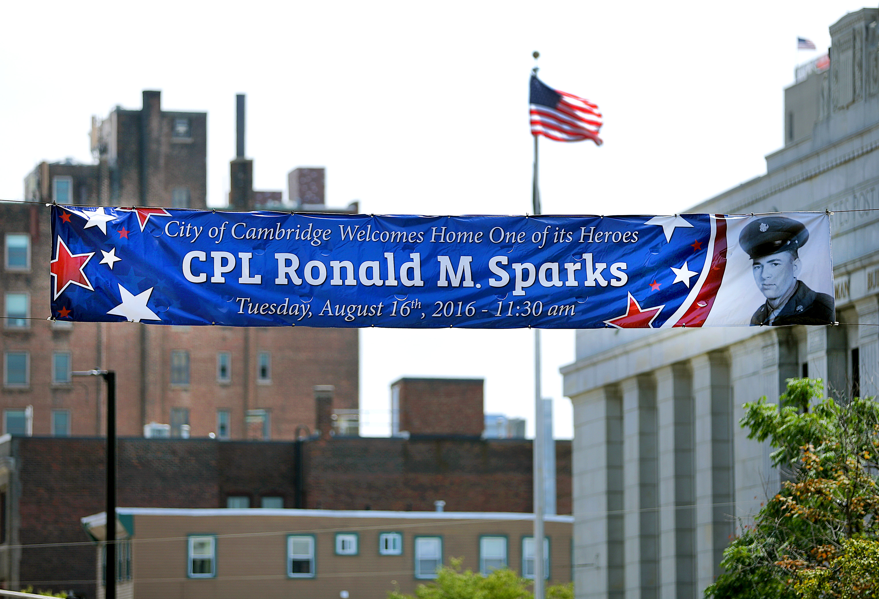 A banner honoring US Army Corporal Ronald M. Sparks, who died in a prisoner-of-war camp in North Korea, was placed over Massachusetts Avenue in front of Cambridge City Hall.