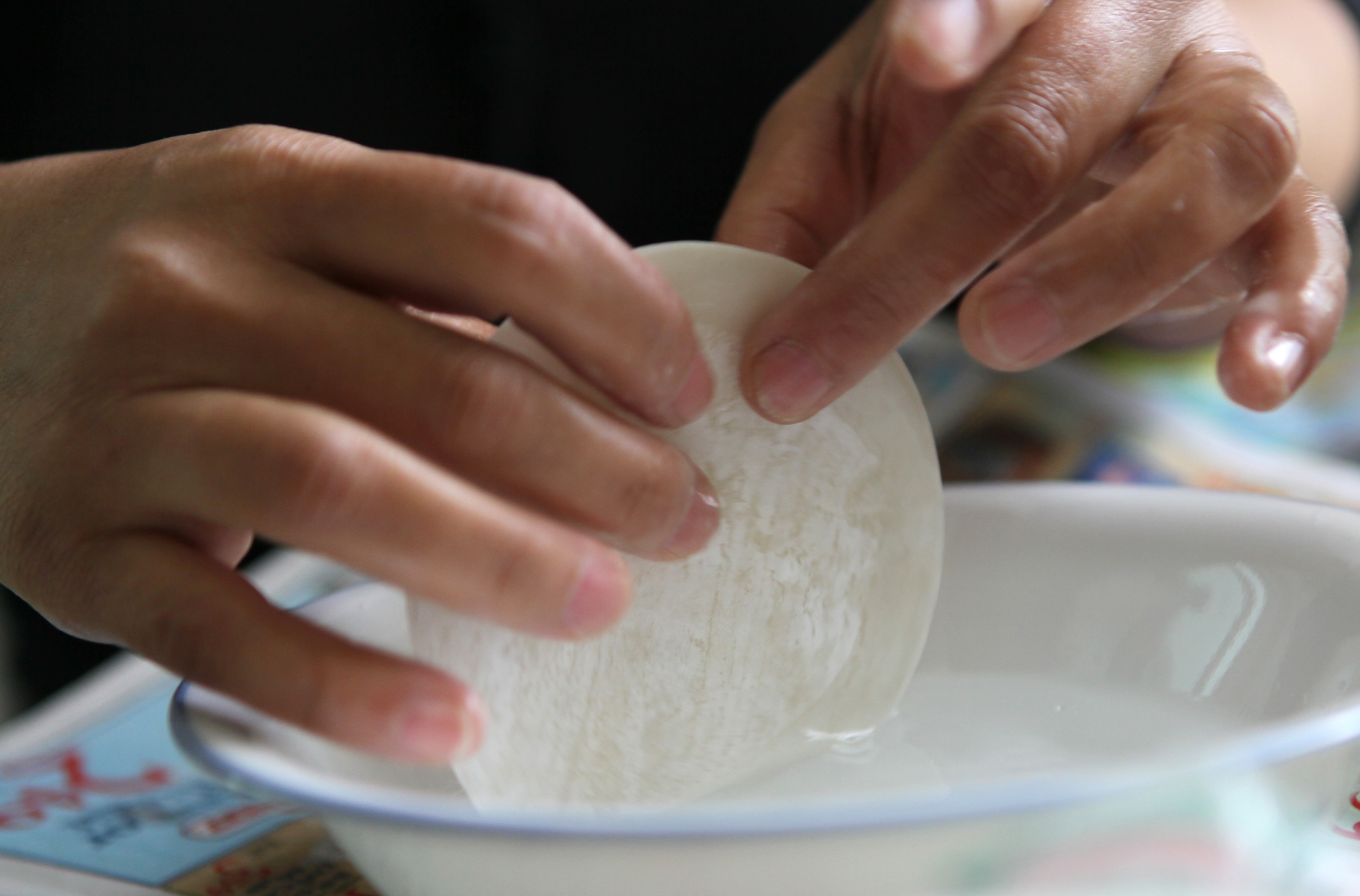 The steps (above, and below ) include swirling dough in water, filling the wrapper, and pinching them shut.