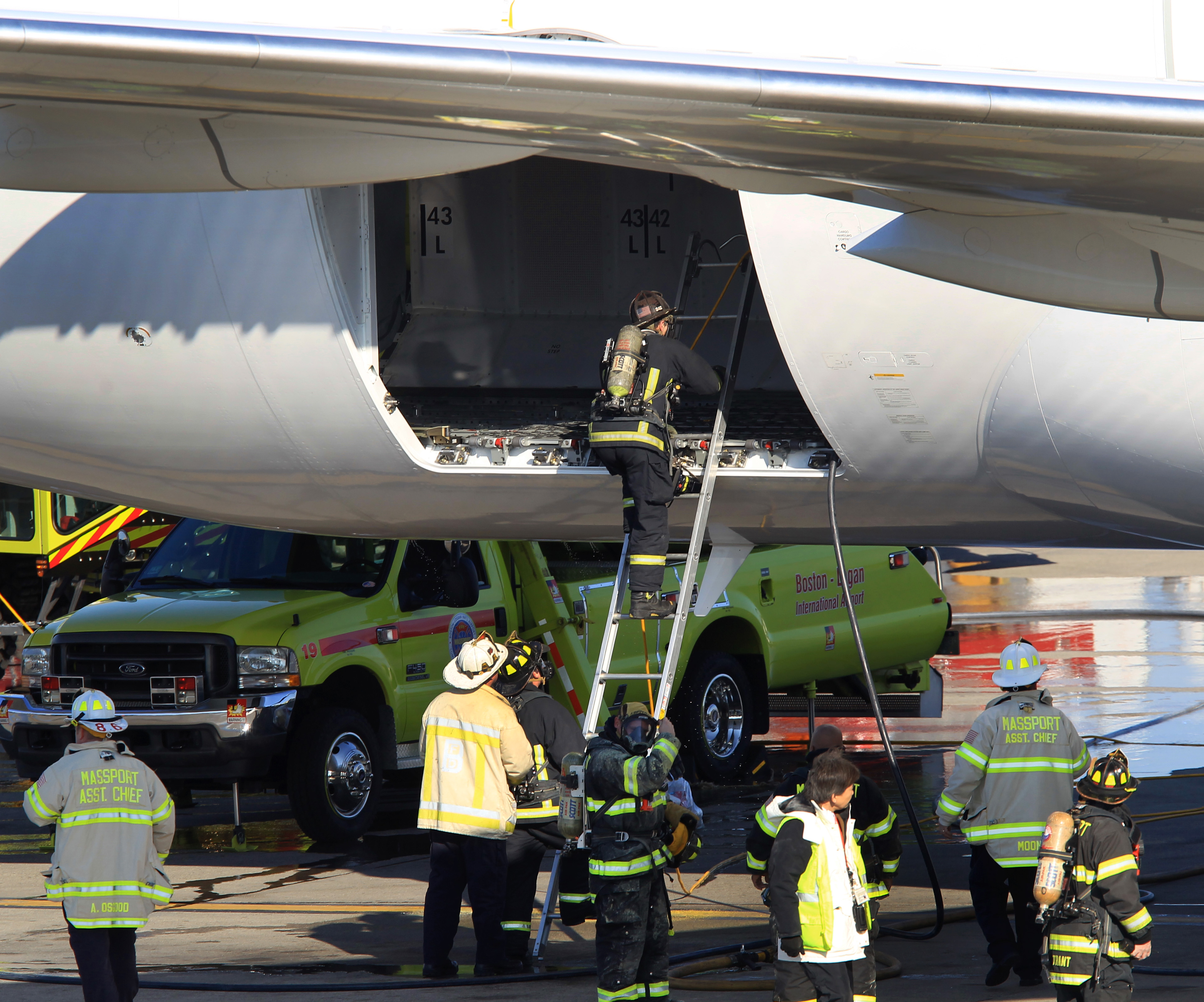 Firefighters checked out the area where a small fire broke out on a Boeing 787 Dreamliner at Logan Airport Monday. The fire knocked out Boston’s only nonstop flight to Asia.