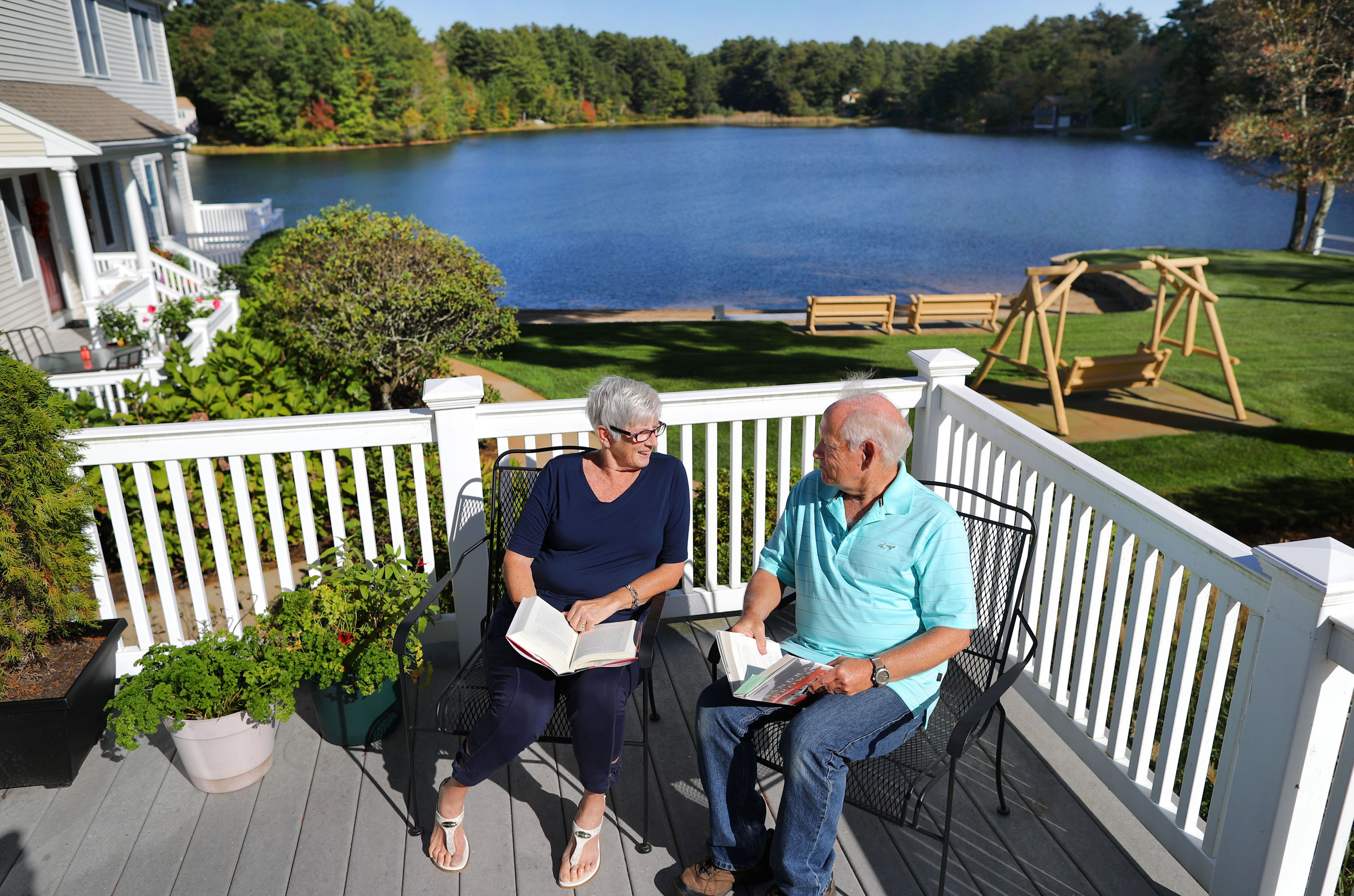 Cheryl and Brad Leonard on the deck of their condo in Plymouth, where they spend hours reading together.
