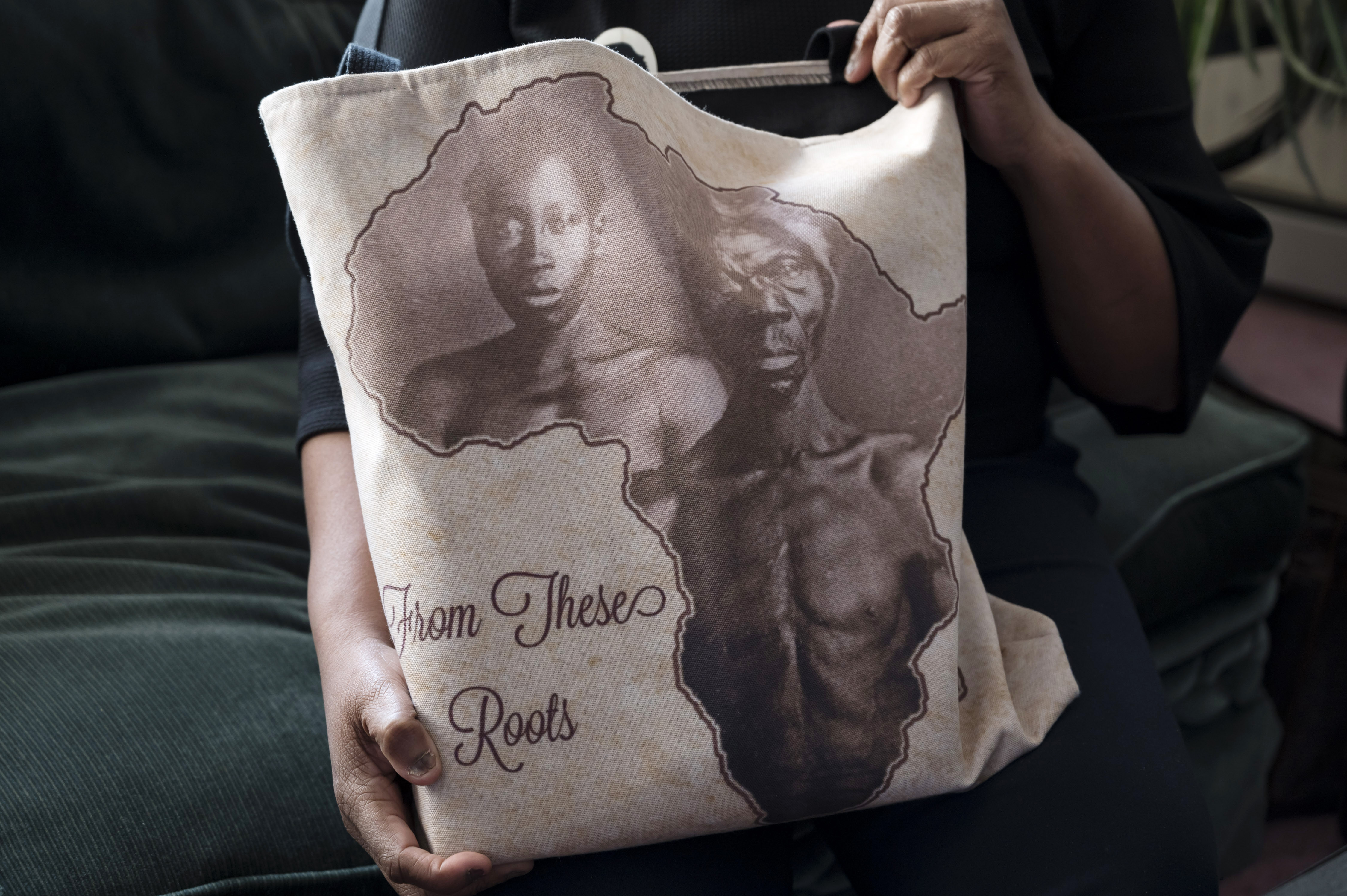 Tamara Lanier held a bag bearing an image of the slaves Renty and Delia, whom she counts as her ancestors, at home in Norwich, Conn.