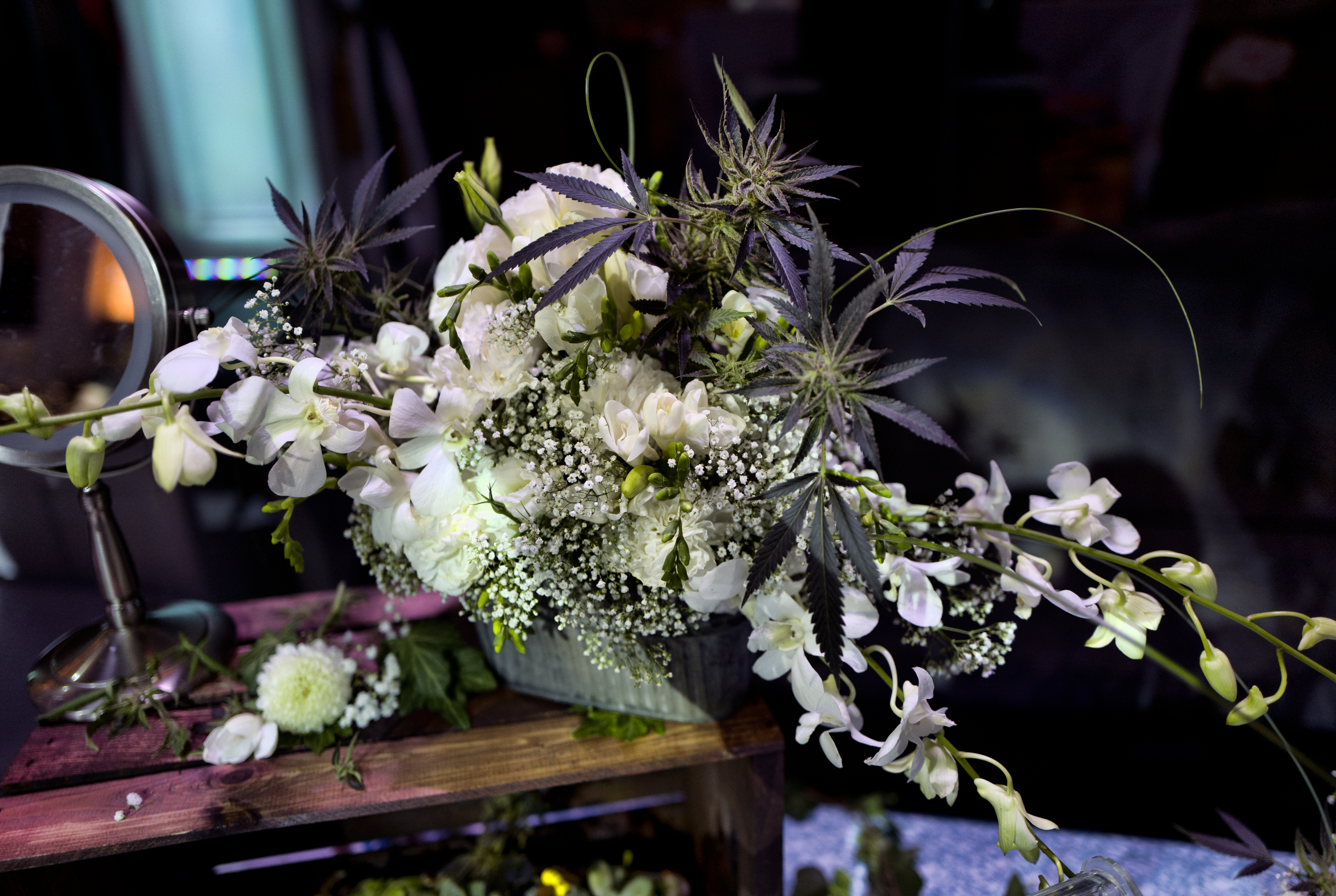 A bouquet handcrafted with fresh flowers, as well as fresh cannabis flowers, is displayed at the Bitchin' Bouquets booth.