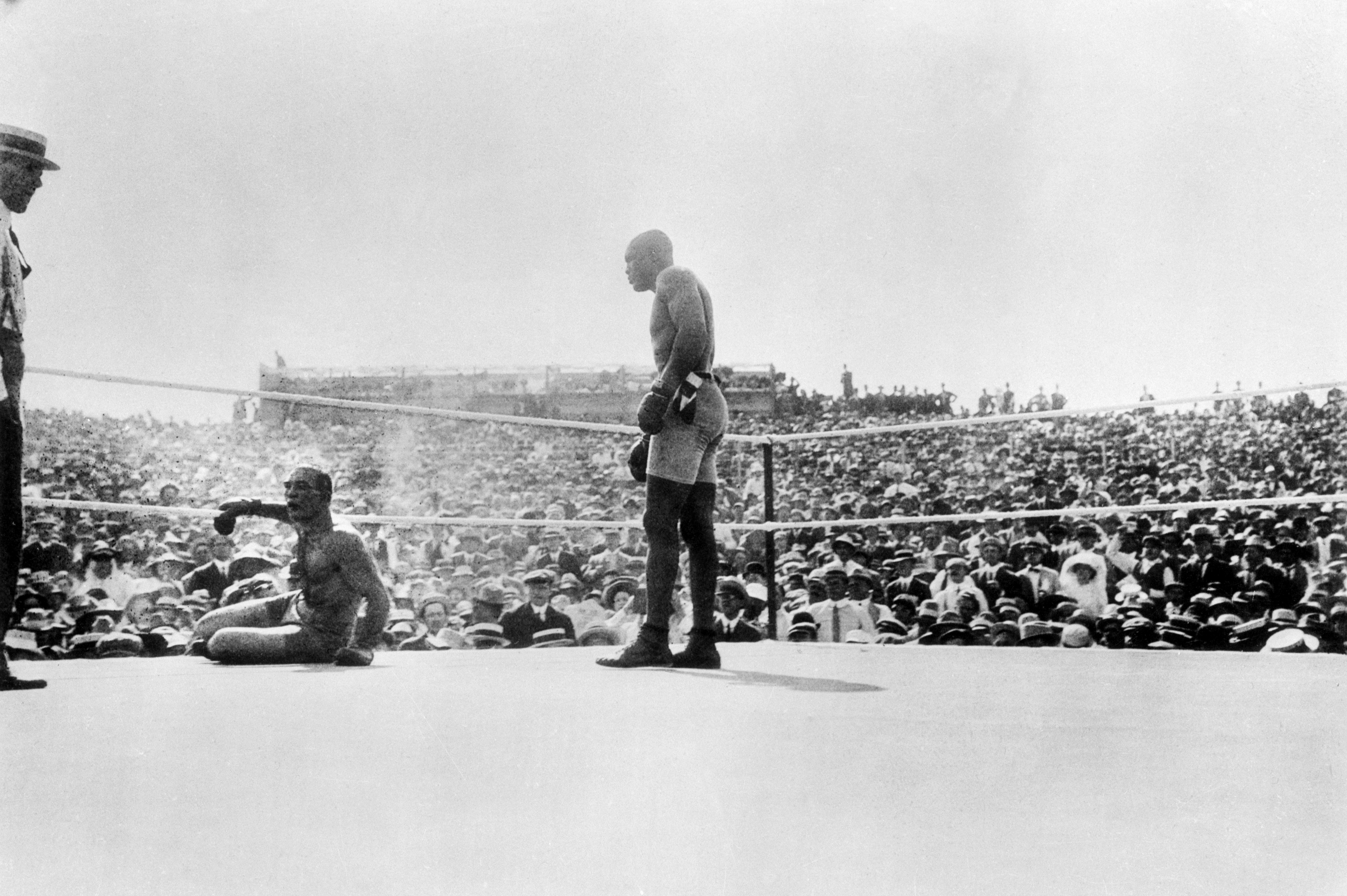 Jack Johnson stands over Jim Jeffries after knocking him down during their bout on July 4, 1910 in Reno.