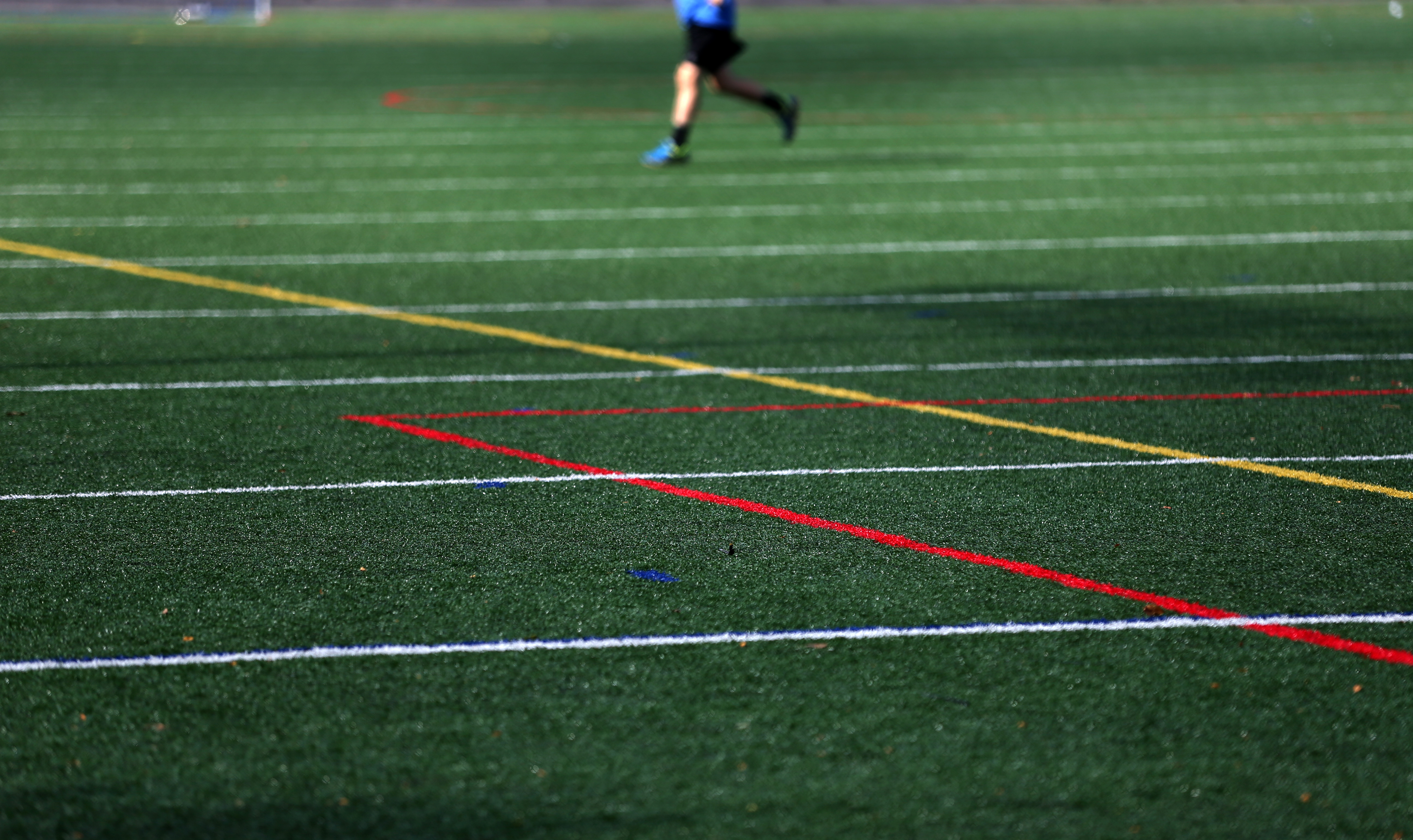 A runner on new turf at the Beaver Street Field at Chilson Park, Beaver Street in Franklin.
