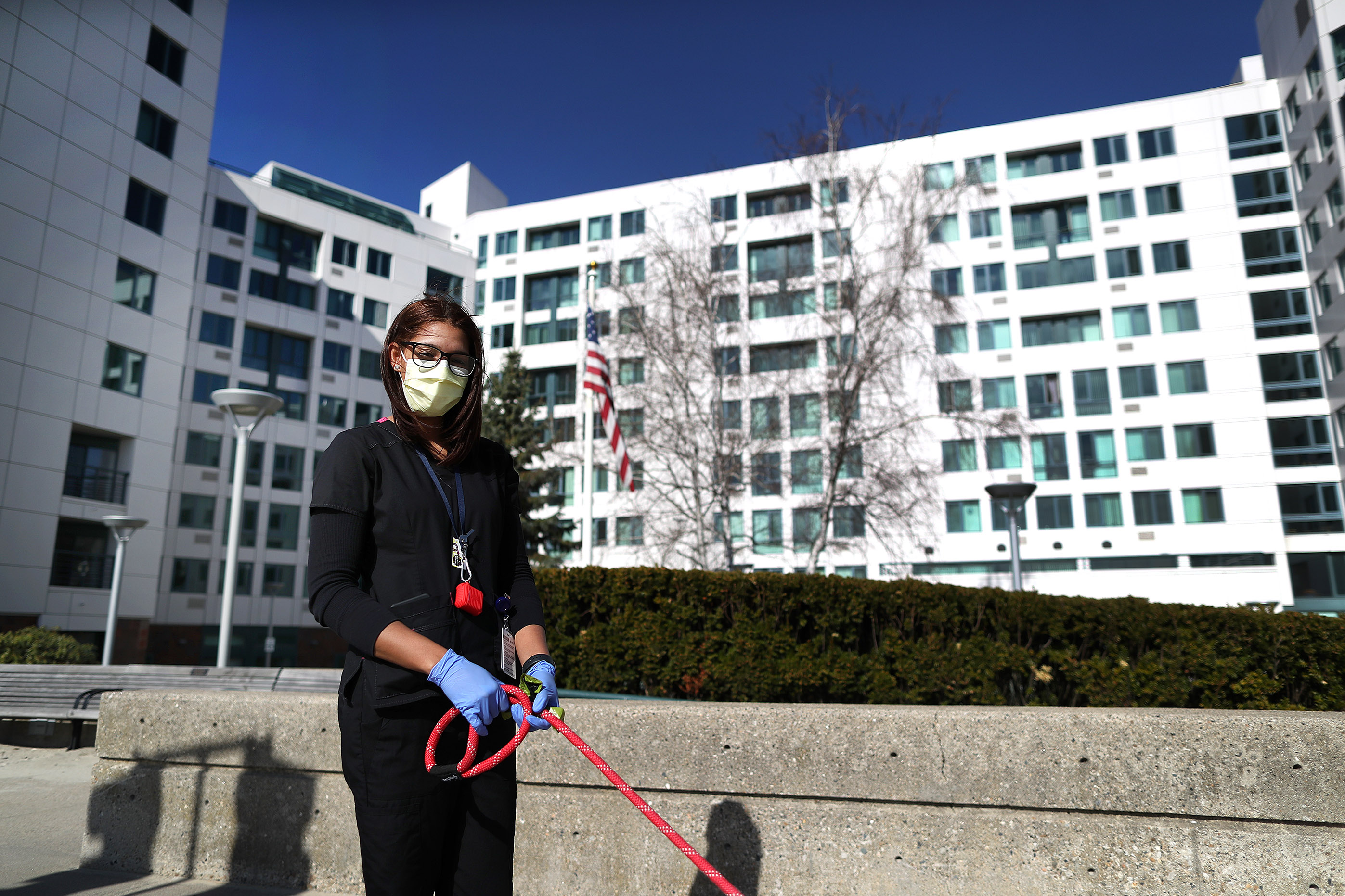 A home health worker at The Jack Satter House in Revere walked a dog on Friday.
