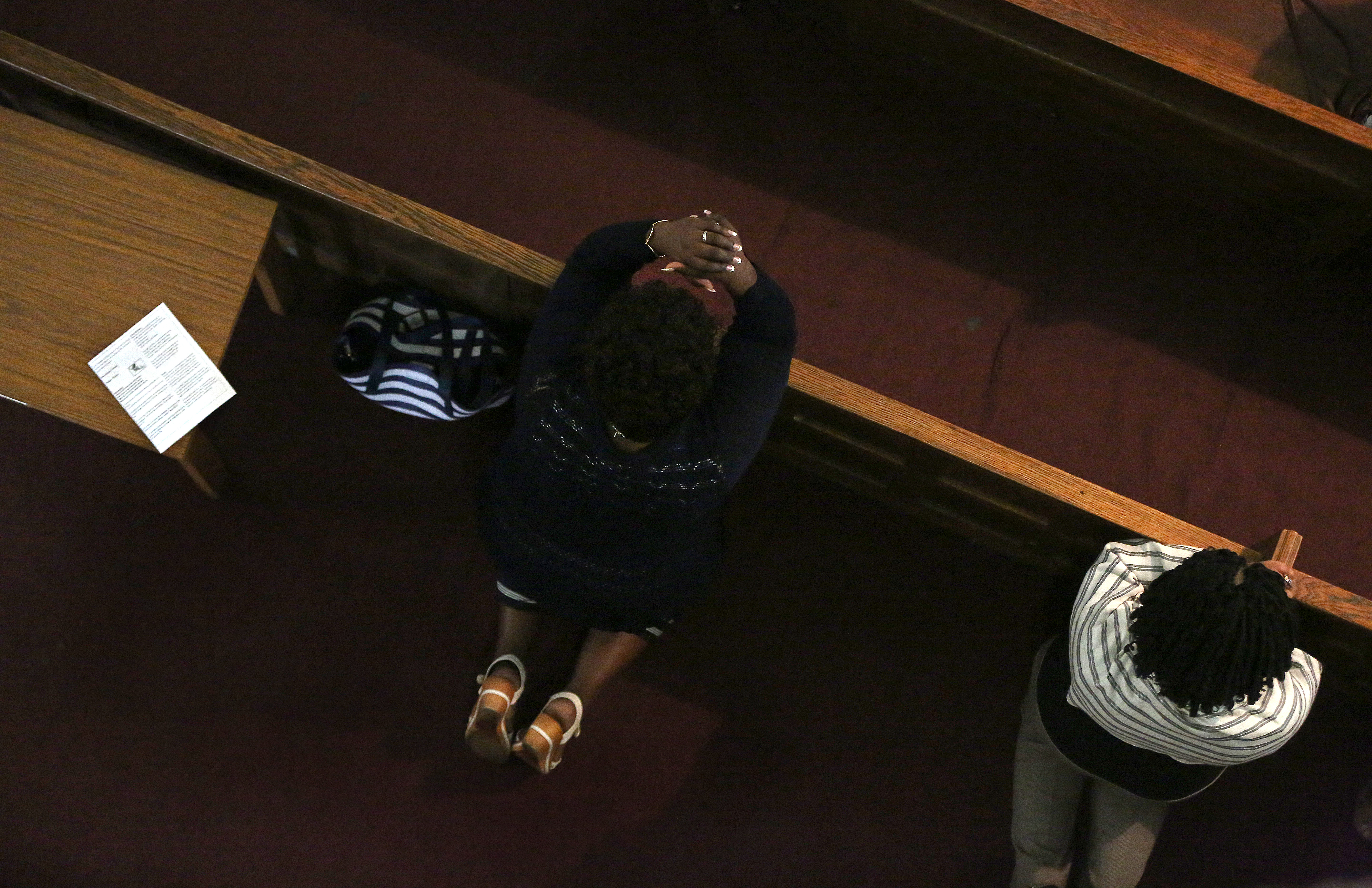 Marianne, attending Mass in Mattapan, came to the United States on a temporary visa in 2008.