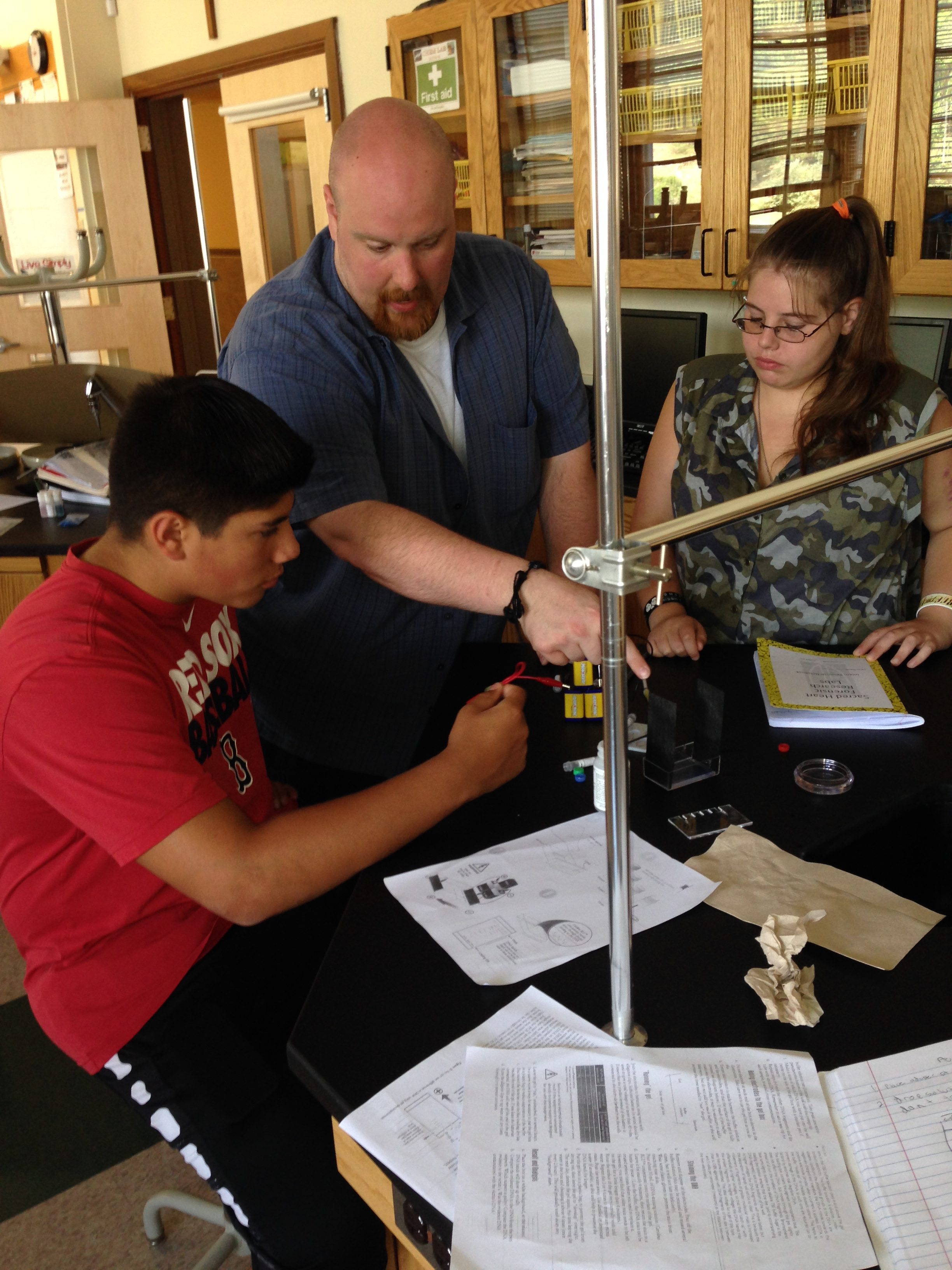 Instructor Greg Morehouse helps forensic science students at Sacred Heart.