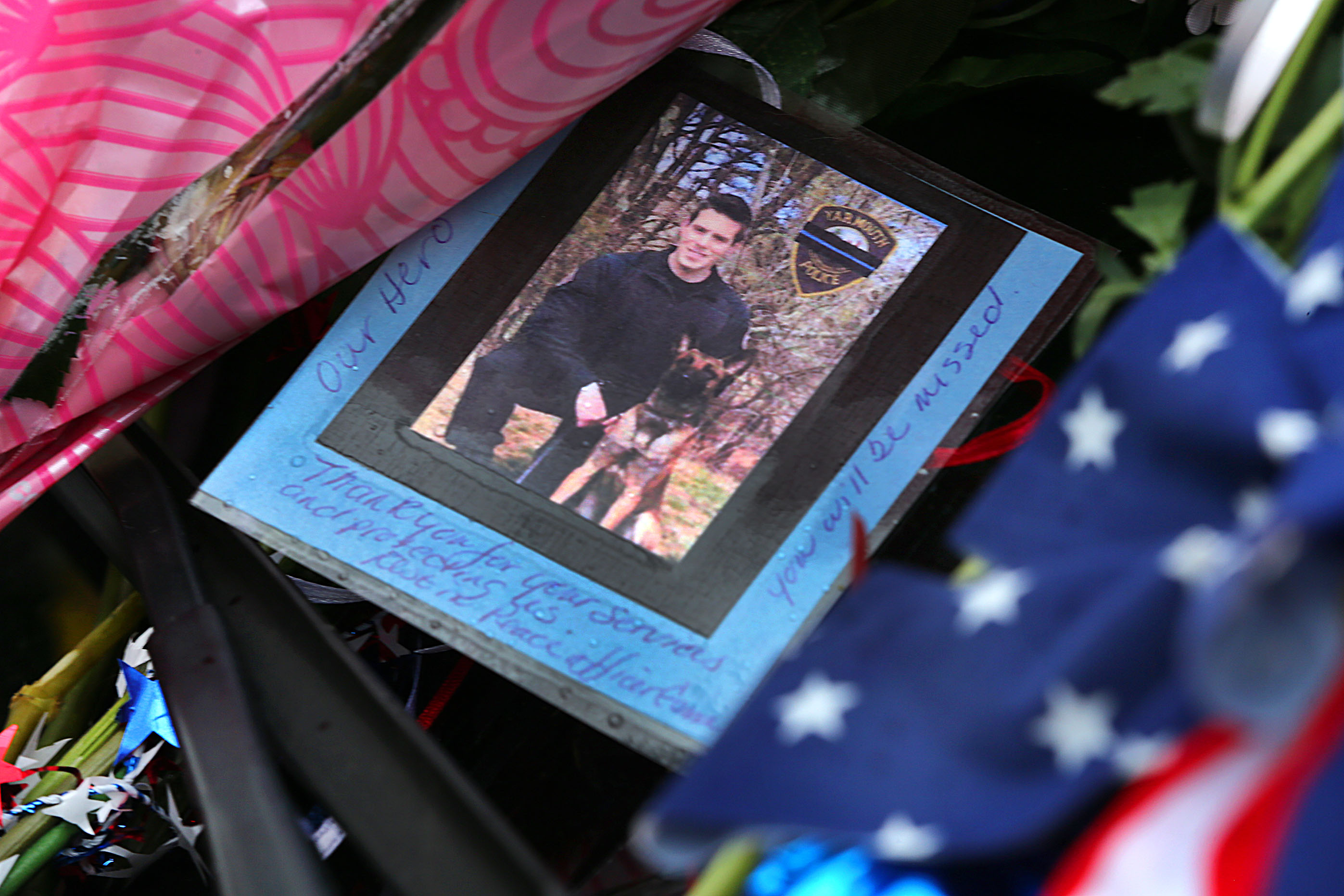 A photograph of slain Yarmouth K-9 officer Sean Gannon and his dog was displayed on the windshield of his cruiser.