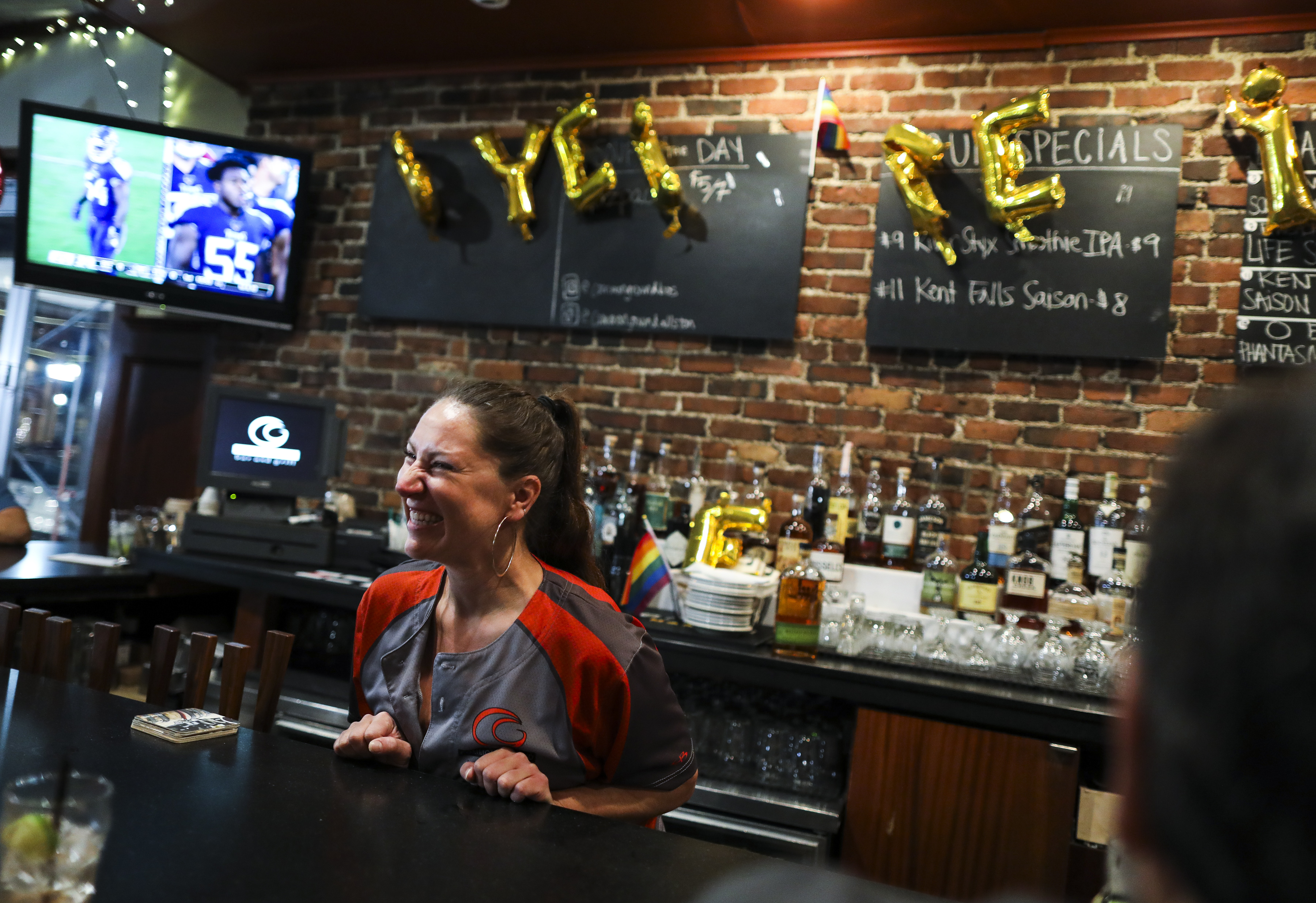 Mercedes "Sadie" Robbins laughed across the bar while servings drinks on the last night Common Ground was open to the public. Robbins has been a bartender at the bar for over 15 years.