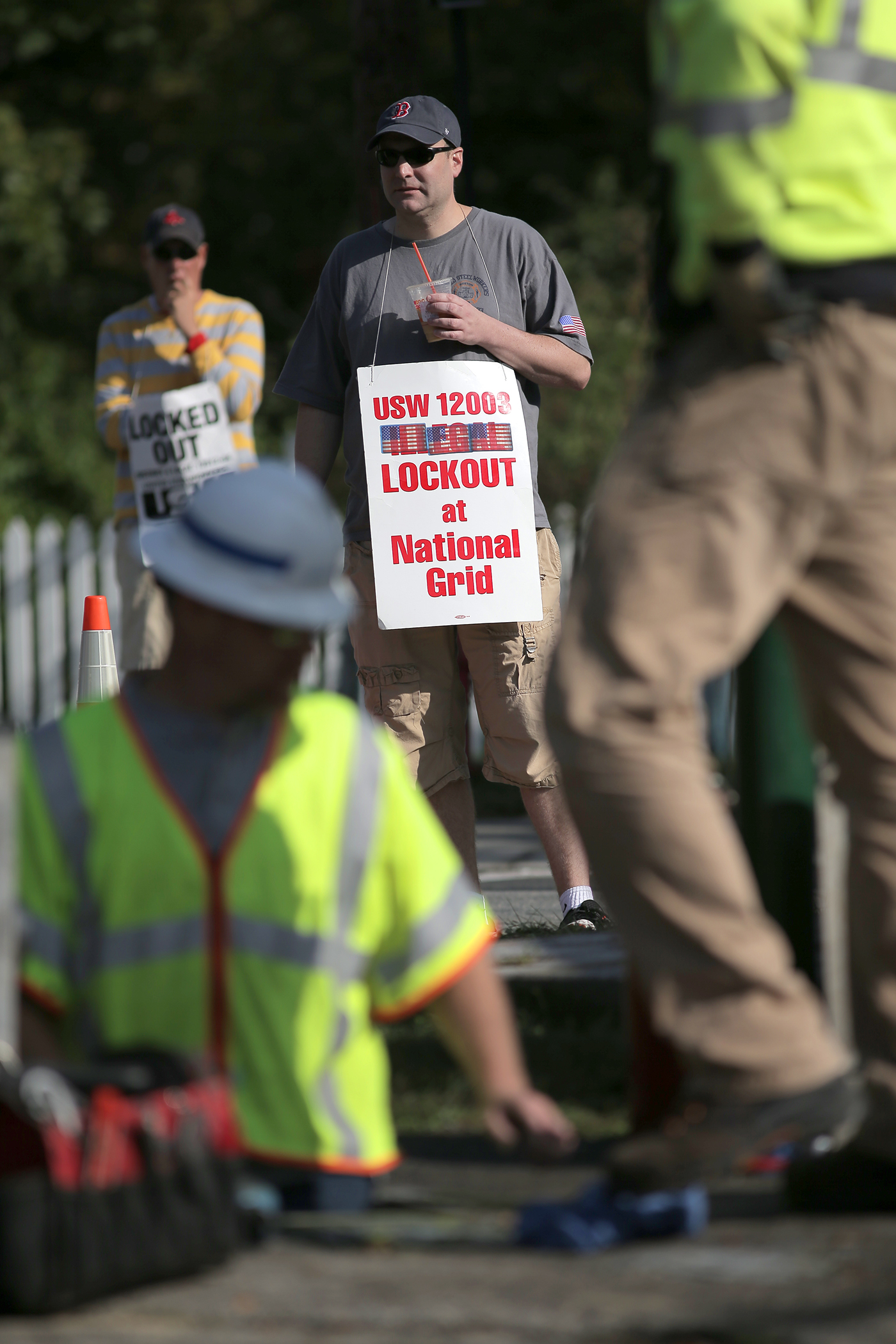 Replacement crews work on a natural gas line on Wyman Street in Woburn after a surge in pressure led officials to cut off service to 300 homes. Locked out National Grid workers used the opportunity to picket the work site.