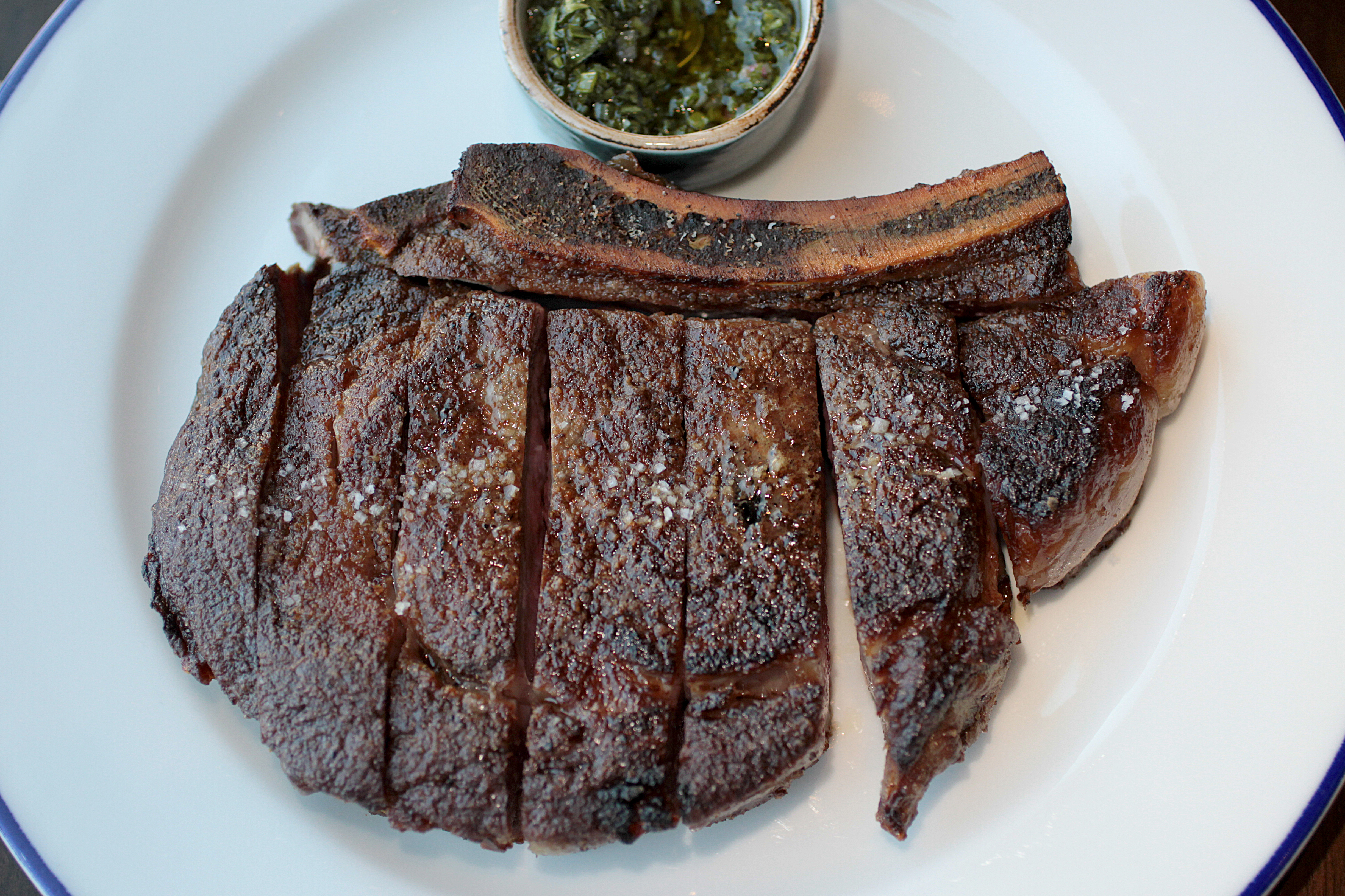 Sliced rib eye for two with marrow bone.