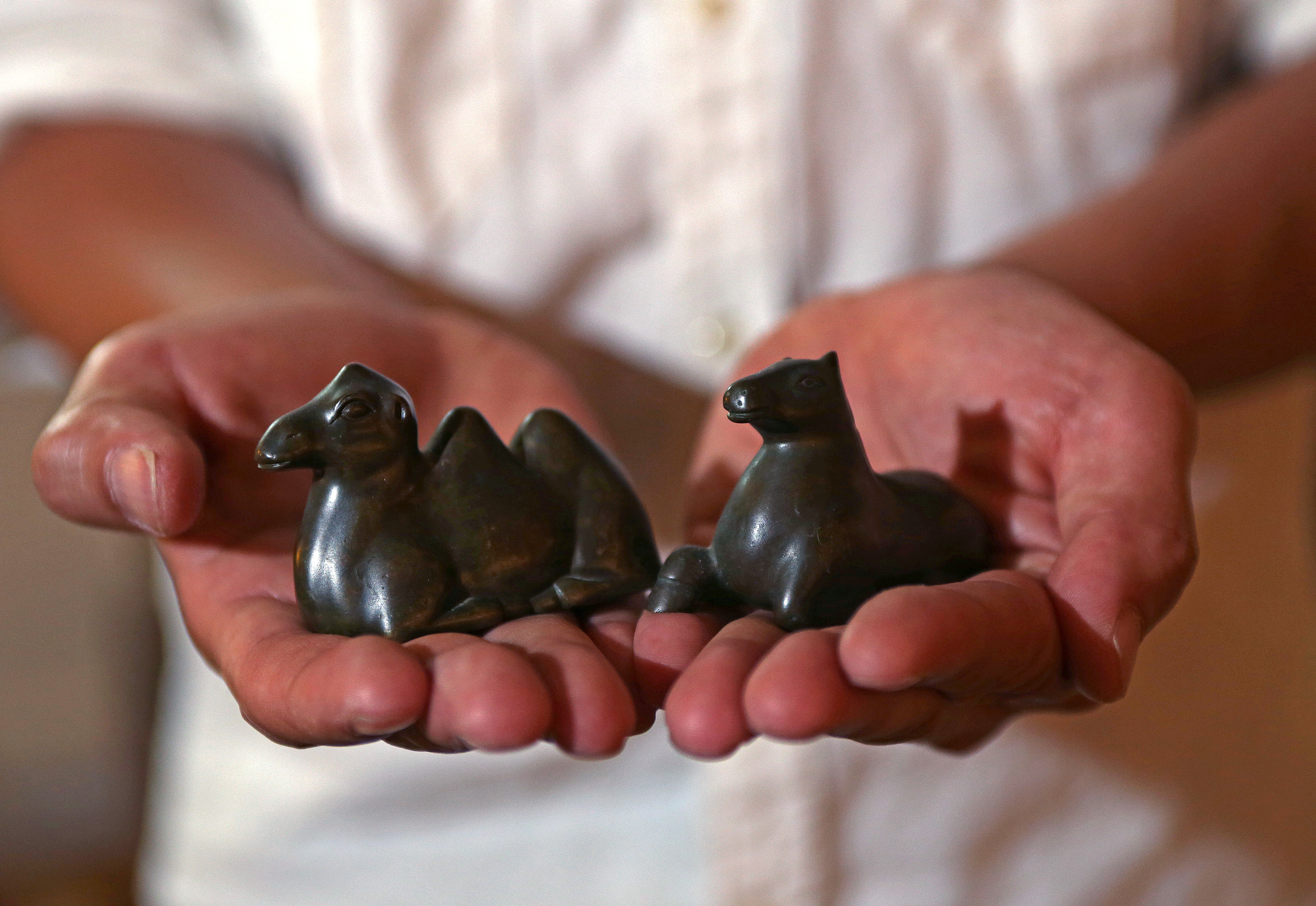 Dien Ho with counter weights used for weighing opium. Ho has loaned some of his mother’s treasures to her alma mater, Williams College.