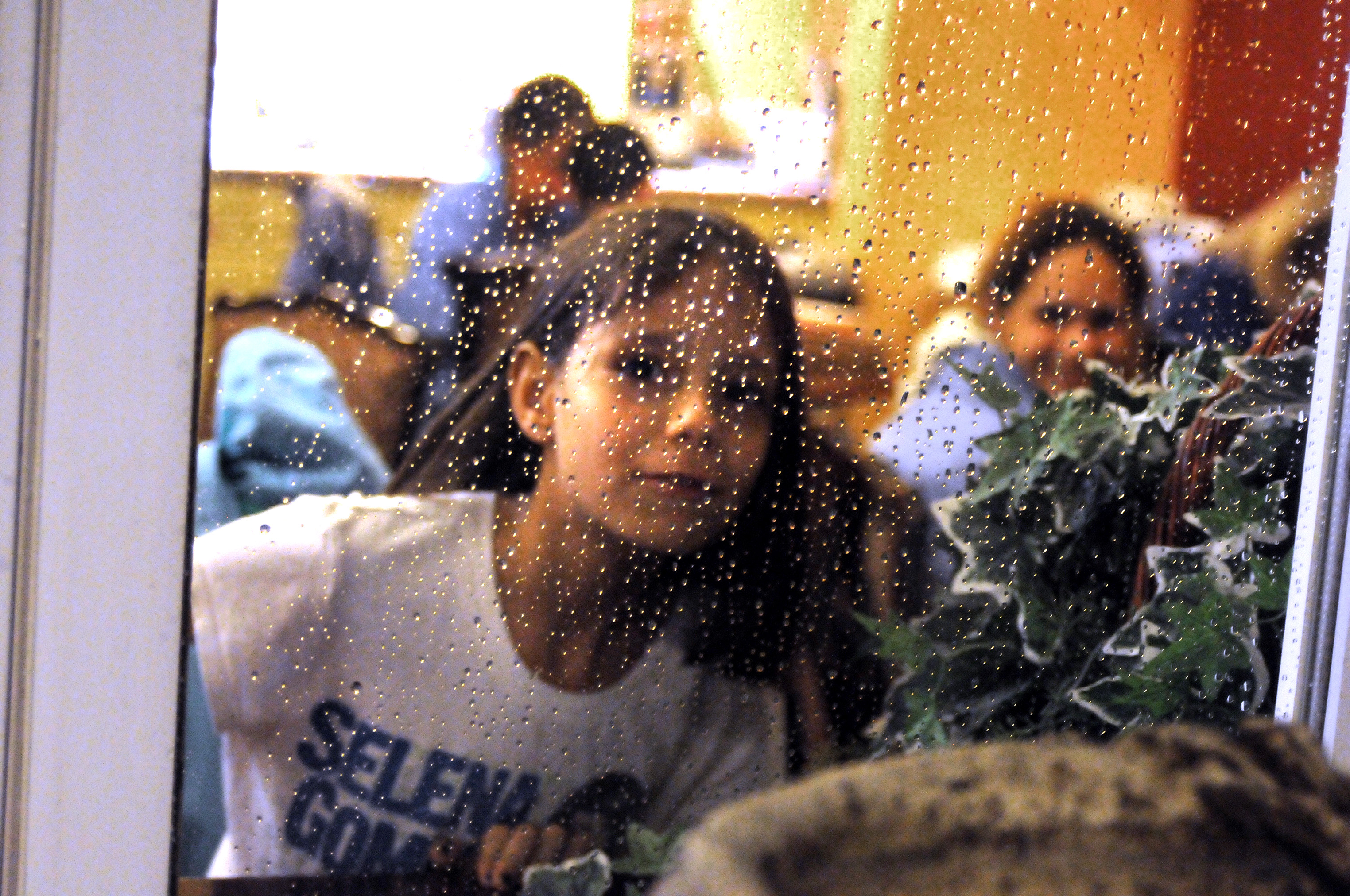 Nine-year-old Emma Precourt peered out a window after a tutoring session for homeless children at the Super 8 in Weymouth.