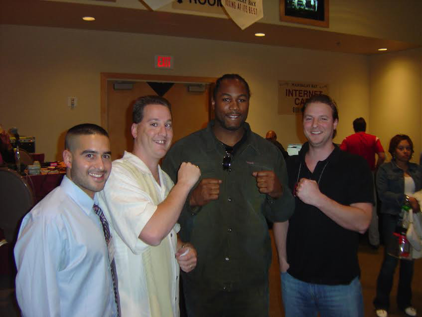 Jon Anik (left), Anthony Pepe and Ryen Russillo pose with Lennox Lewis. The trio took the air near the end of 1510's run as "The Diehards."