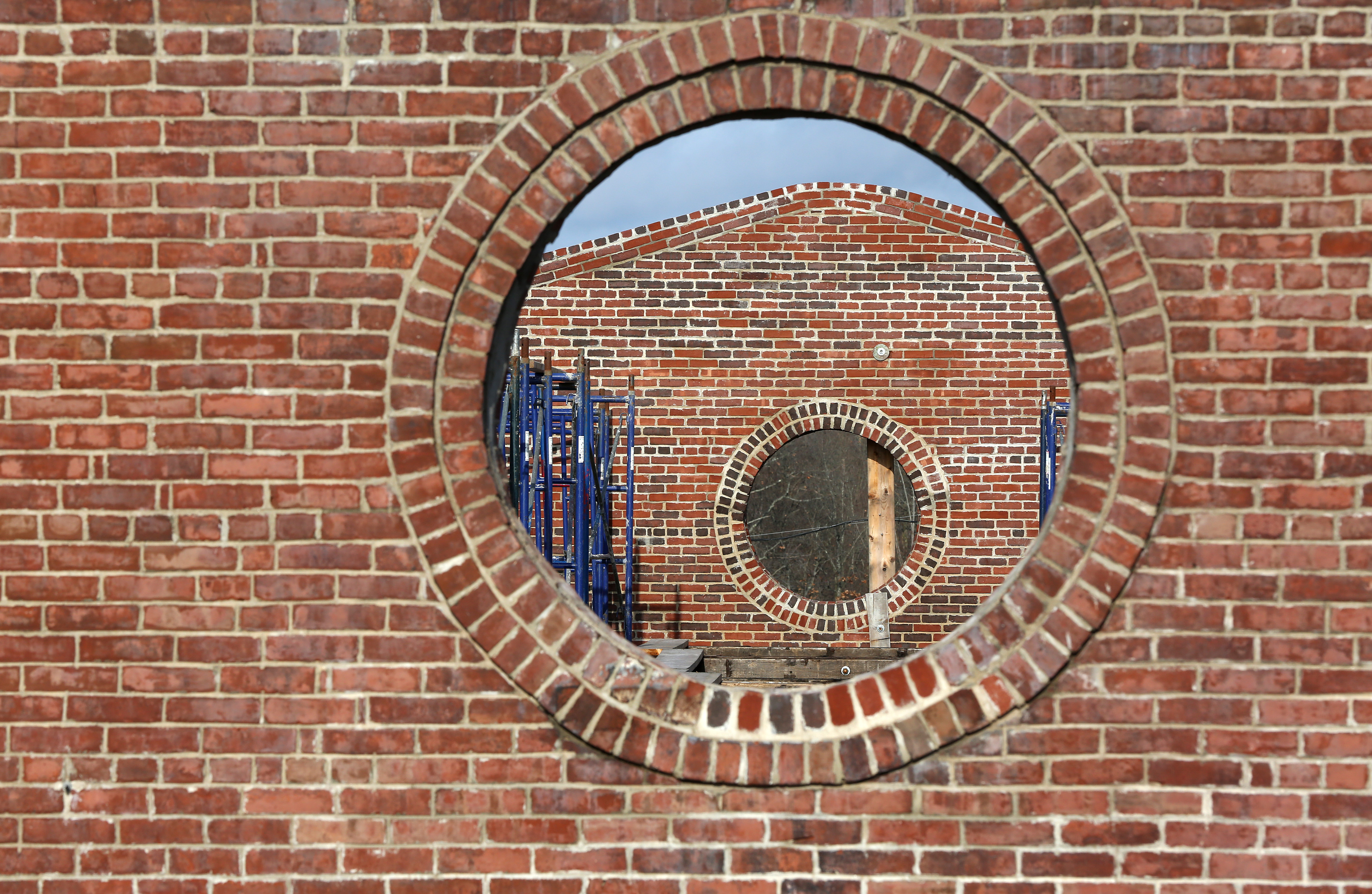 Two round stained-glass windows will be installed in the sides of the Revere & Son Copper Rolling Mill building.