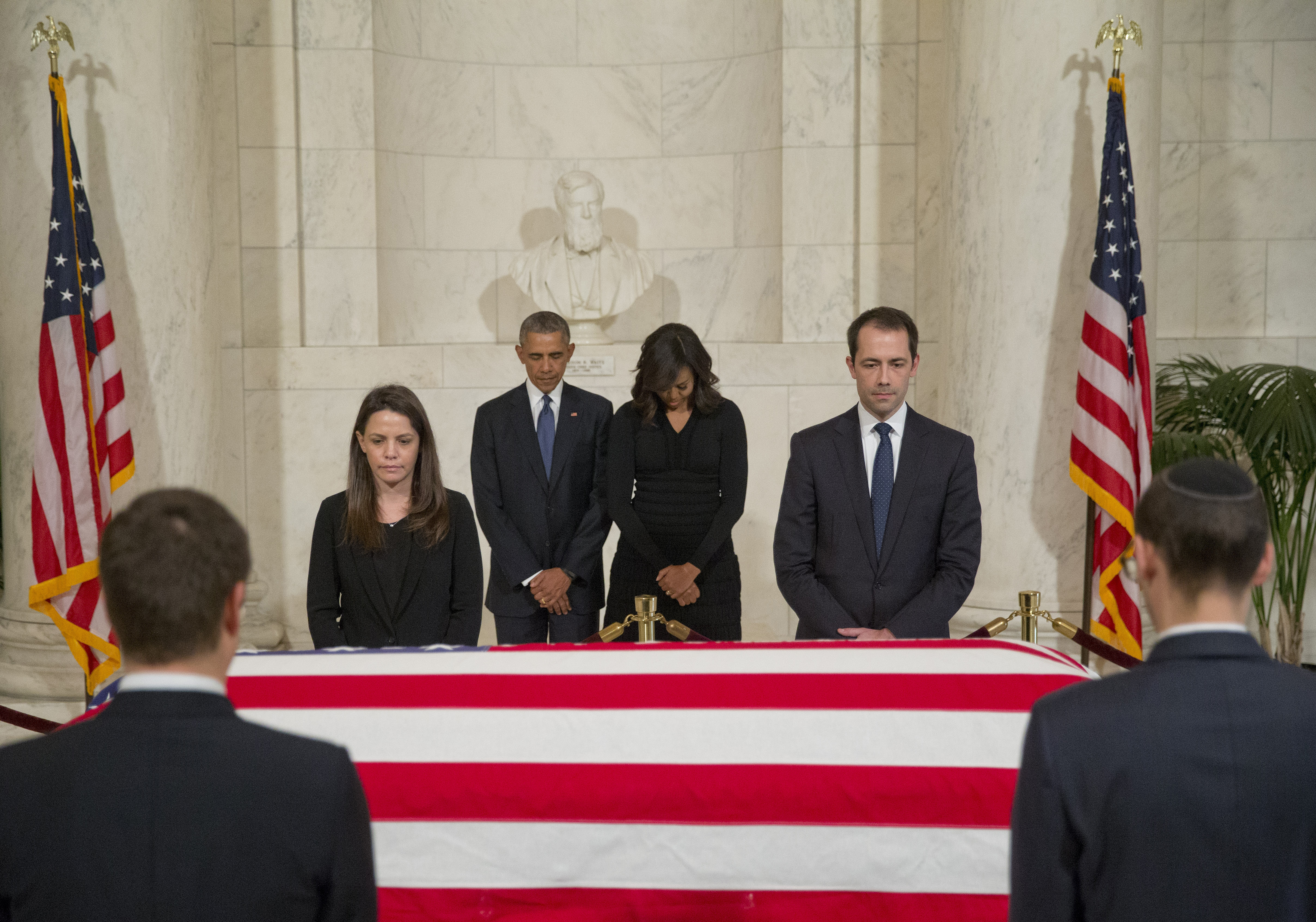 President Barack Obama and first lady Michelle Obama paused as they paid respects beside the casket of Associated Justice Antonin Scalia as it lies in the Great Hall of the Supreme Court on Friday.