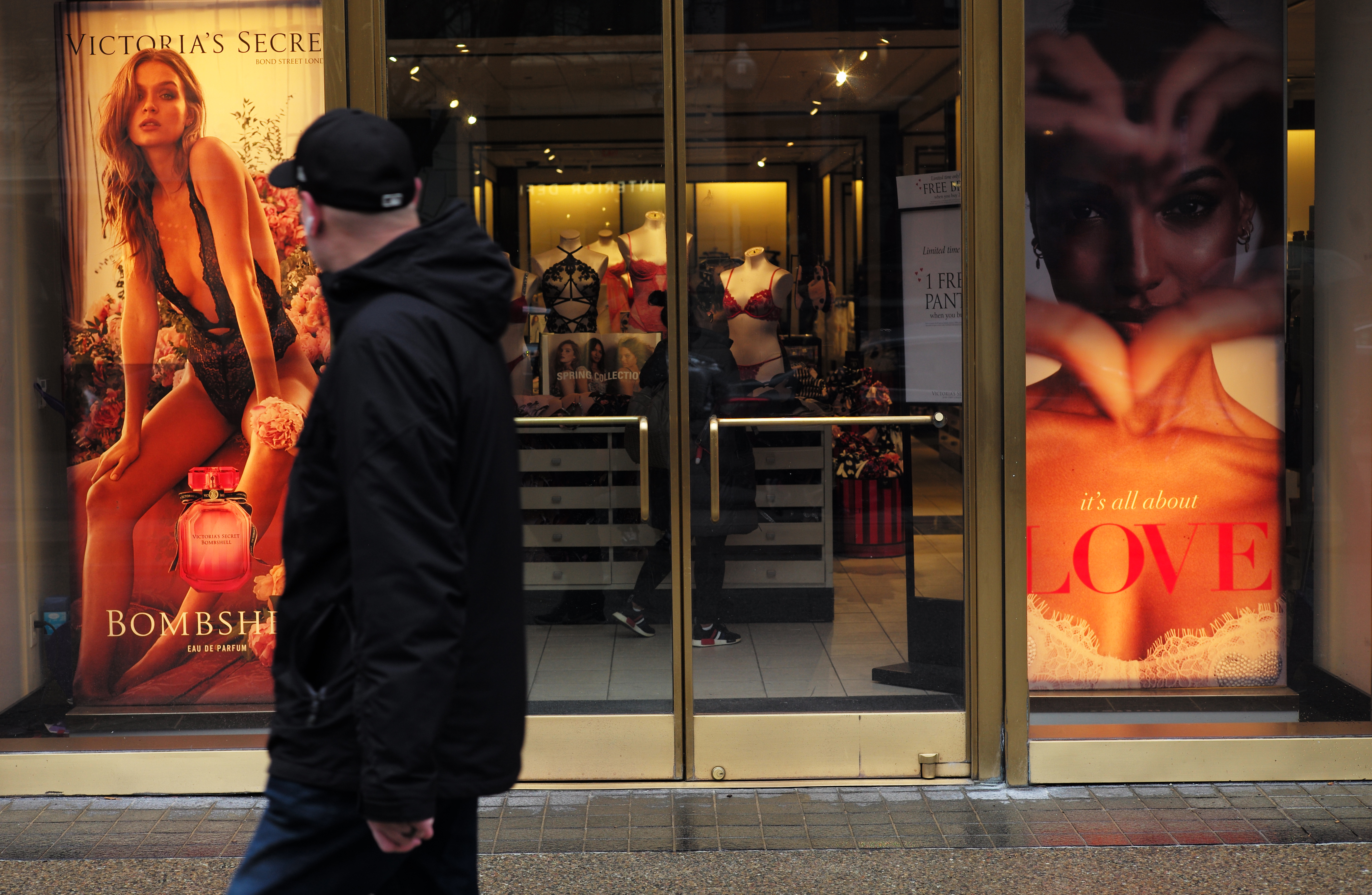 A man walked by Victoria's Secret on Newbury Street in Boston.