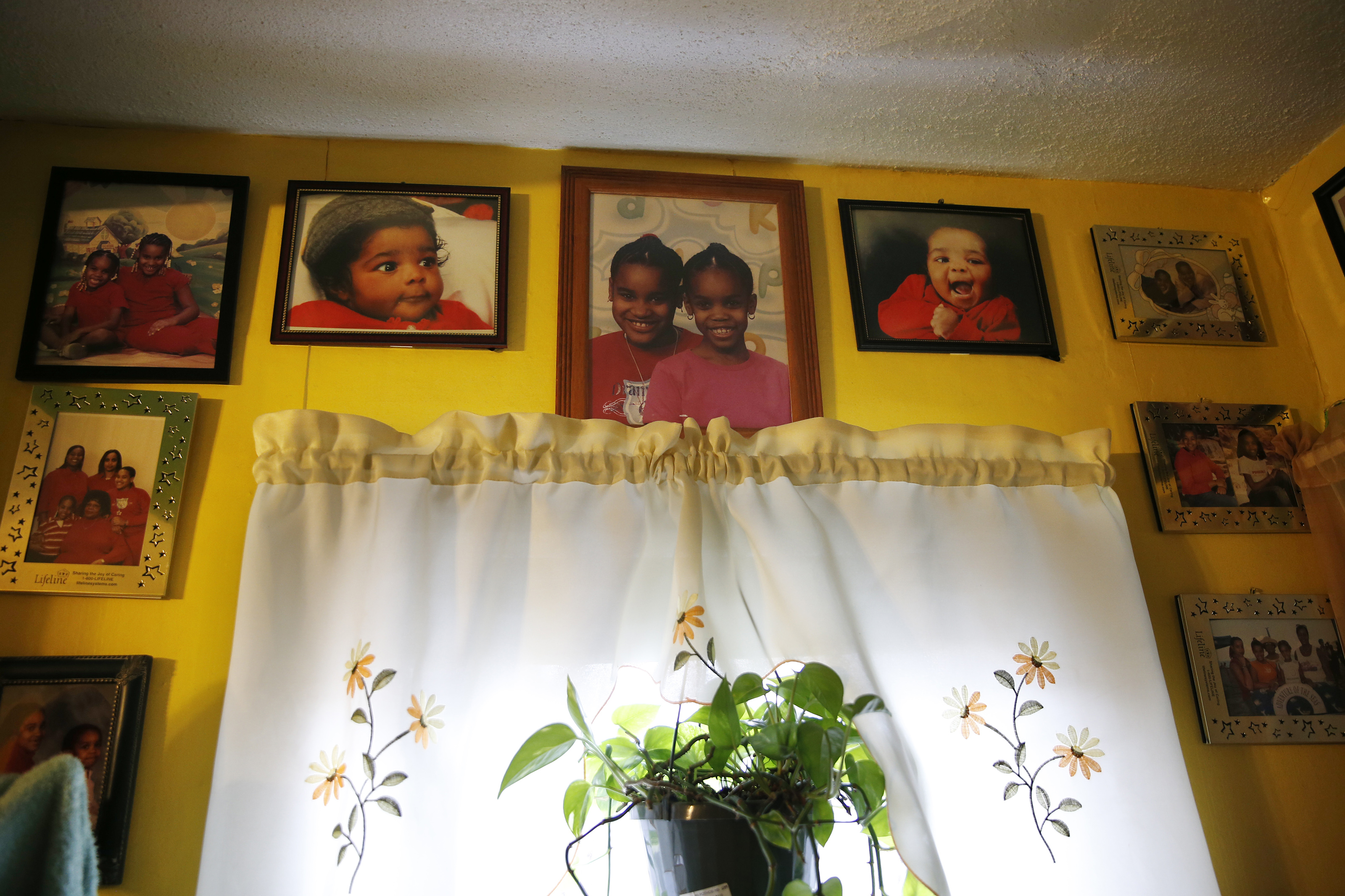 Family photos line the walls inside Marcelle Harrison's home at 6 Ashburton Place, where she has lived for almost 40 years.