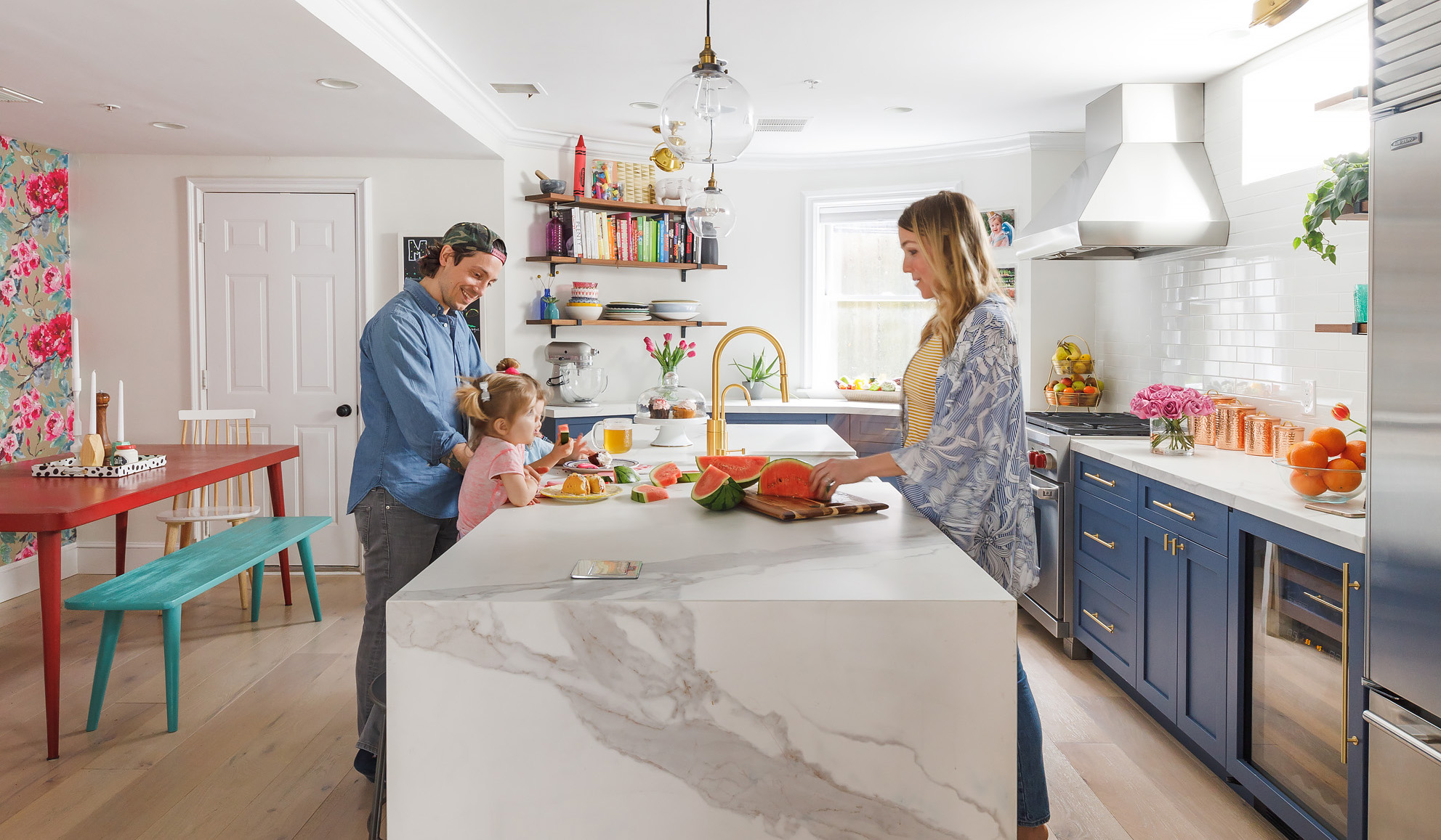 White subway tile with a handmade feel is clean and classic. “We didn’t want the backsplash to make a statement,” designer Caitlin Flynn says. The dining table and bench came from the couple’s last apartment.