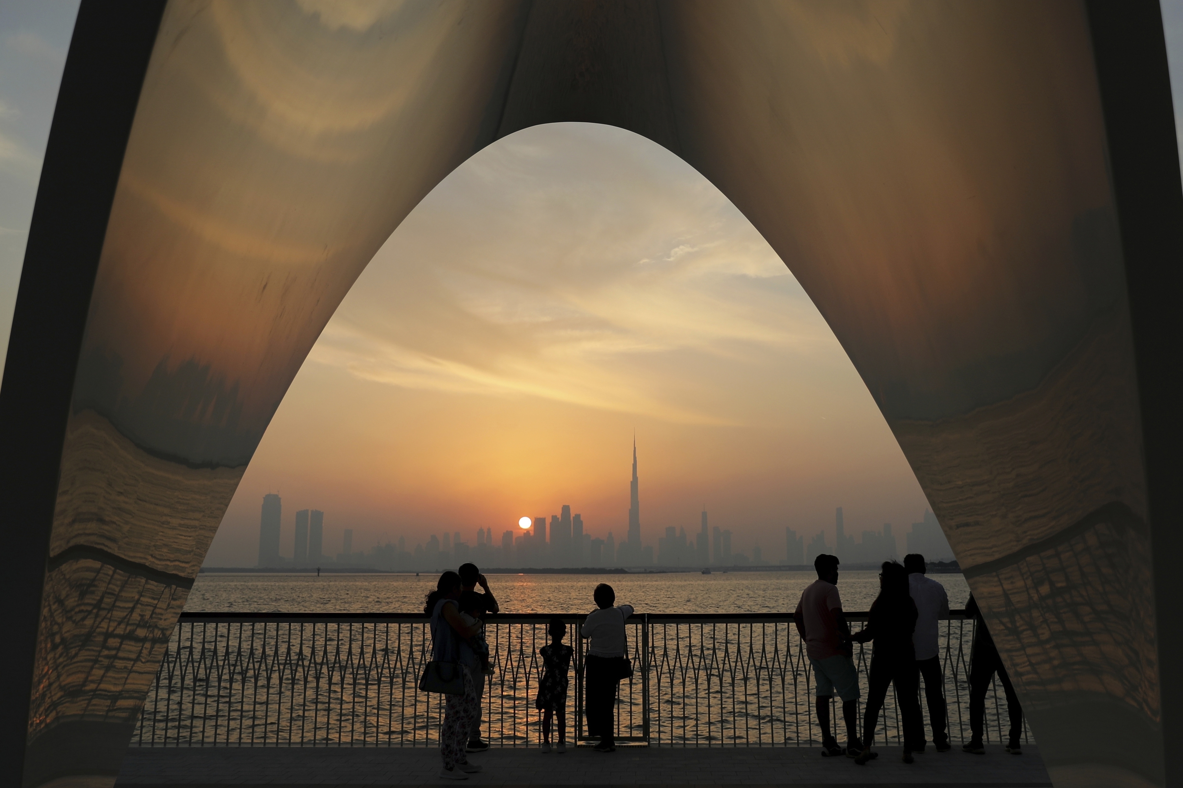 People enjoy a city skyline view with the World's tallest building, Burj Khalifa, in Dubai.