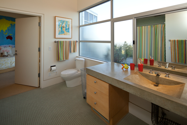 Grab-bars alone don't make a bathroom safer. Other accessible features include spacious toilet areas for wheelchair transfer or assisted use and a shallow sink that's open to below for a seated user. “The Accessible Home” (The Taunton Press)