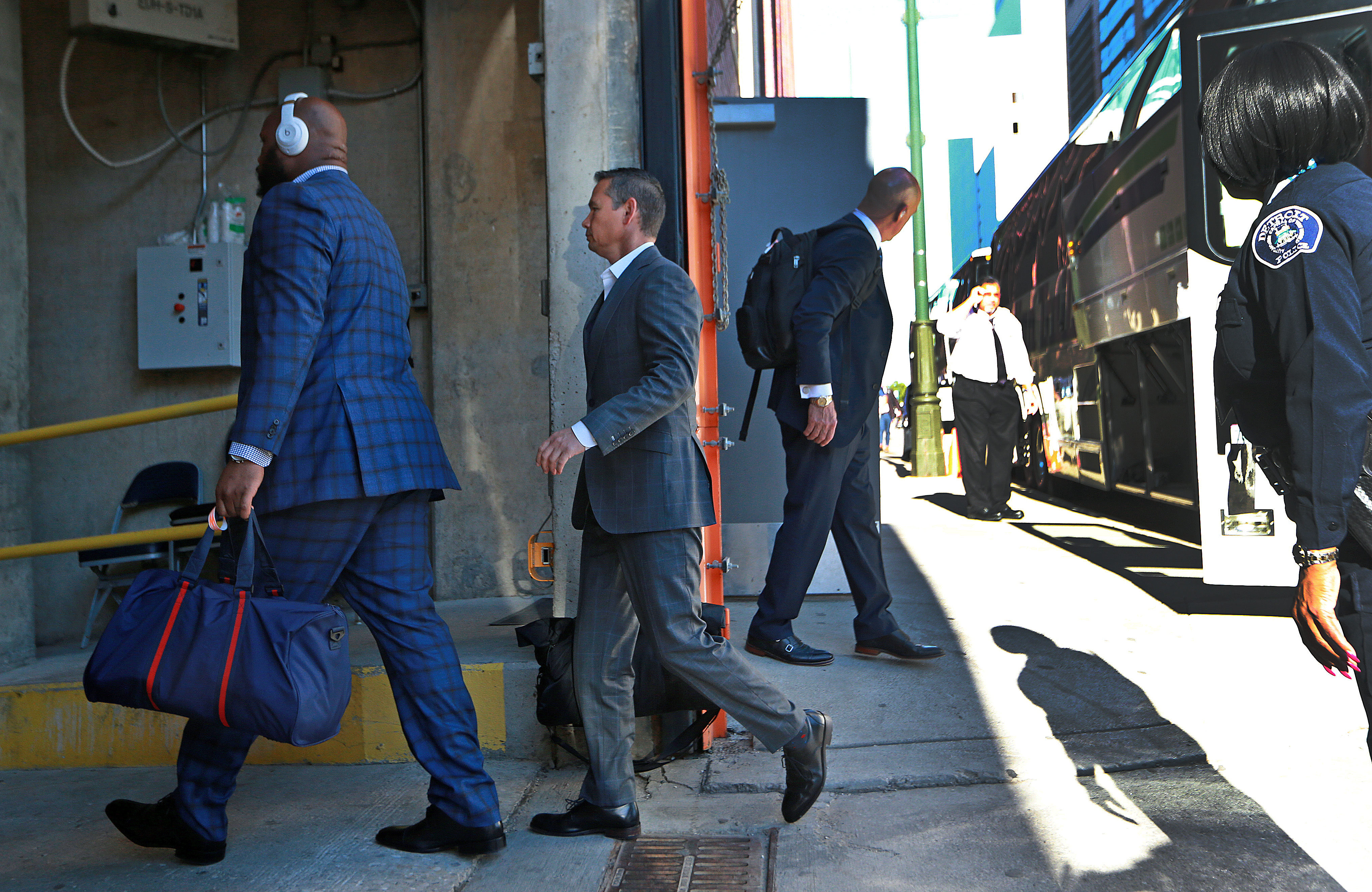 Alex Guerrero (center) is pictured as he gets off the team bus and heads into the stadium with players, including Marcus Cannon (left).