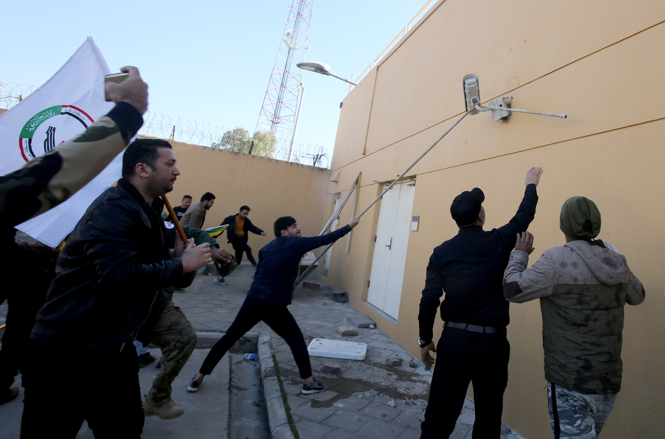 Iraqi protesters breached the outer wall of the US embassy in Baghdad during a demonstration.