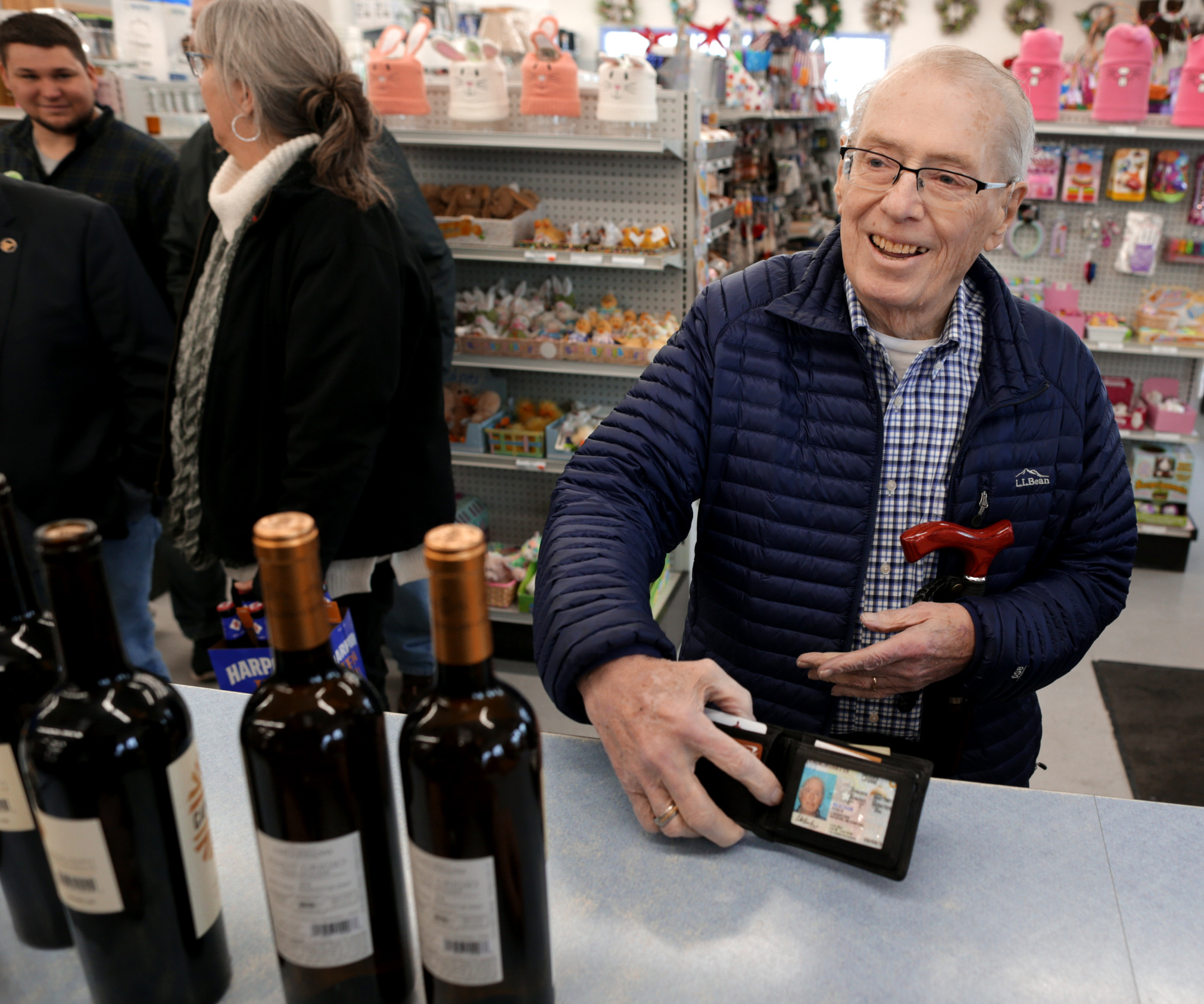 Peter Beacham flashed his license as he was the first to purchase wine at the market.