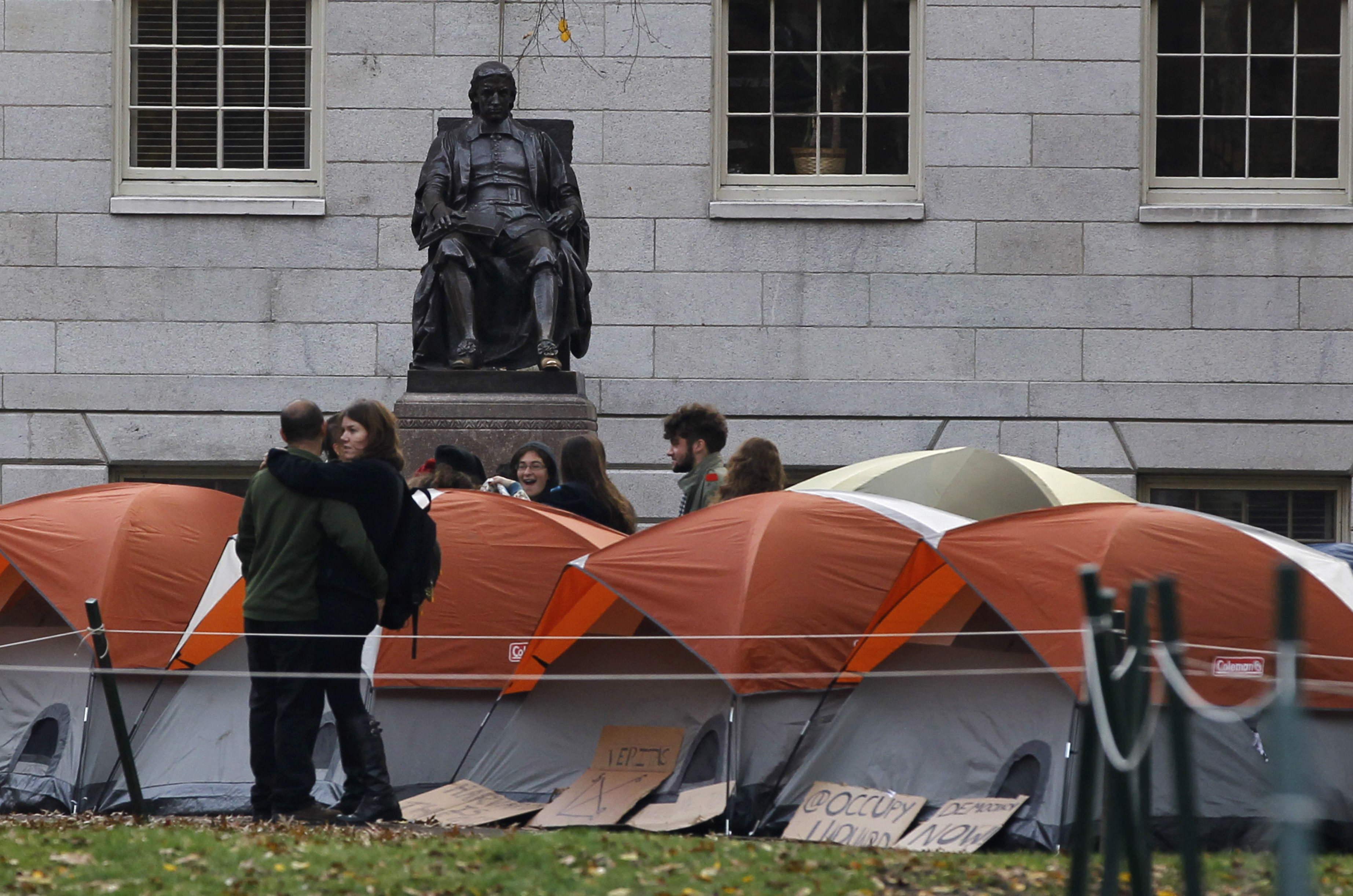 A cluster of tents near a statue of Harvard University founder John Harvard today.