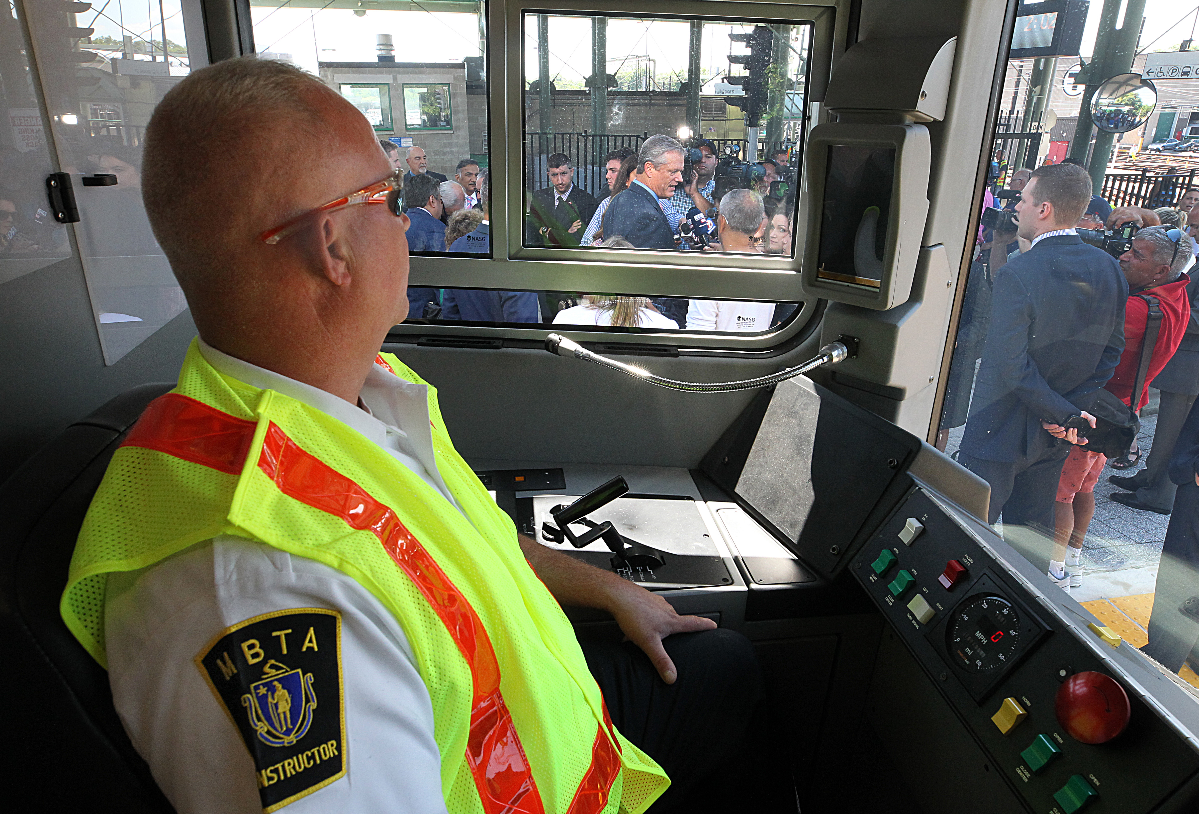 MBTA instructor Ed Bezzati, who trains motormen, waited in the new train while Governor Charlie Baker spoke to the media after he received a tour of the new Green Line trolley at Riverside Station.