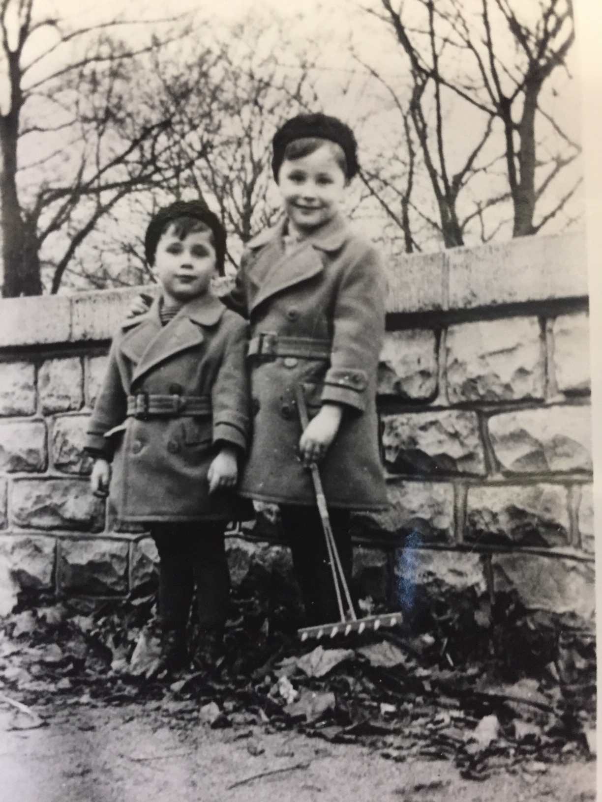 A young Peter Gossels (right), raking leaves with his younger brother, Werner, in Berlin as boys.
