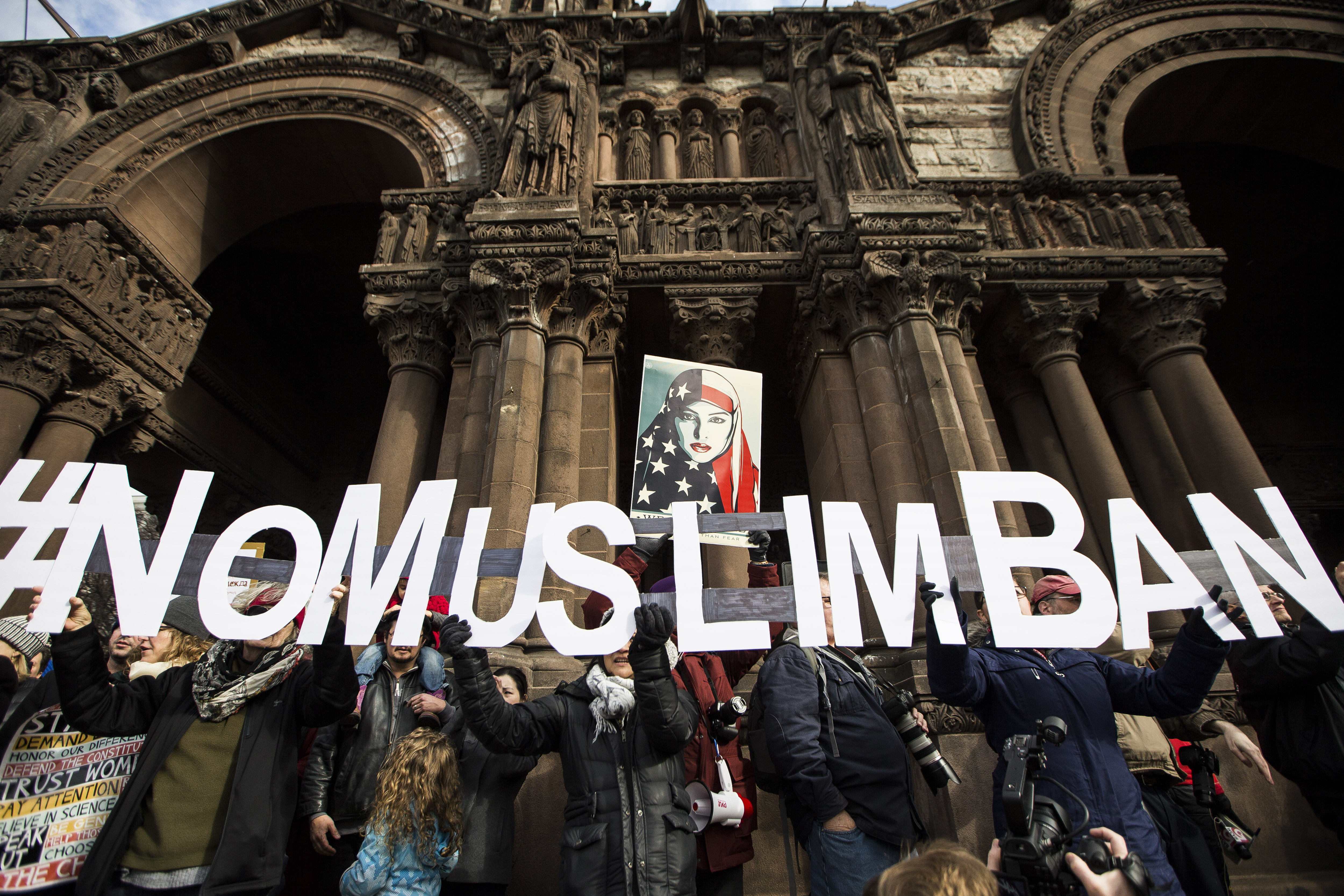 A group of protesters held up letters spelling out #NoMuslimBan in Copley Square.