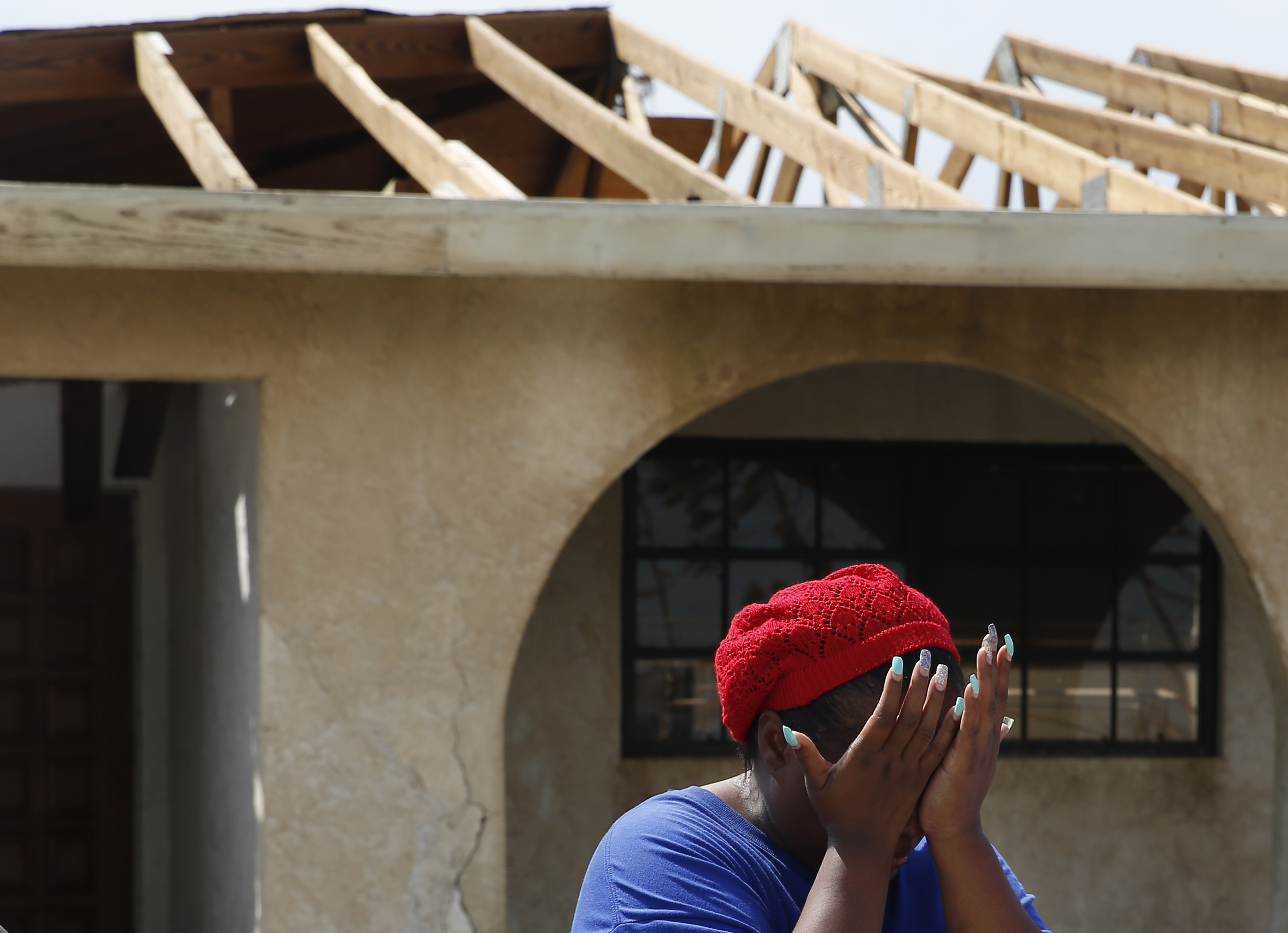 Tiffany Baillou broke down upon seeing a family member arrive at her home for the first time since Hurricane Dorian.