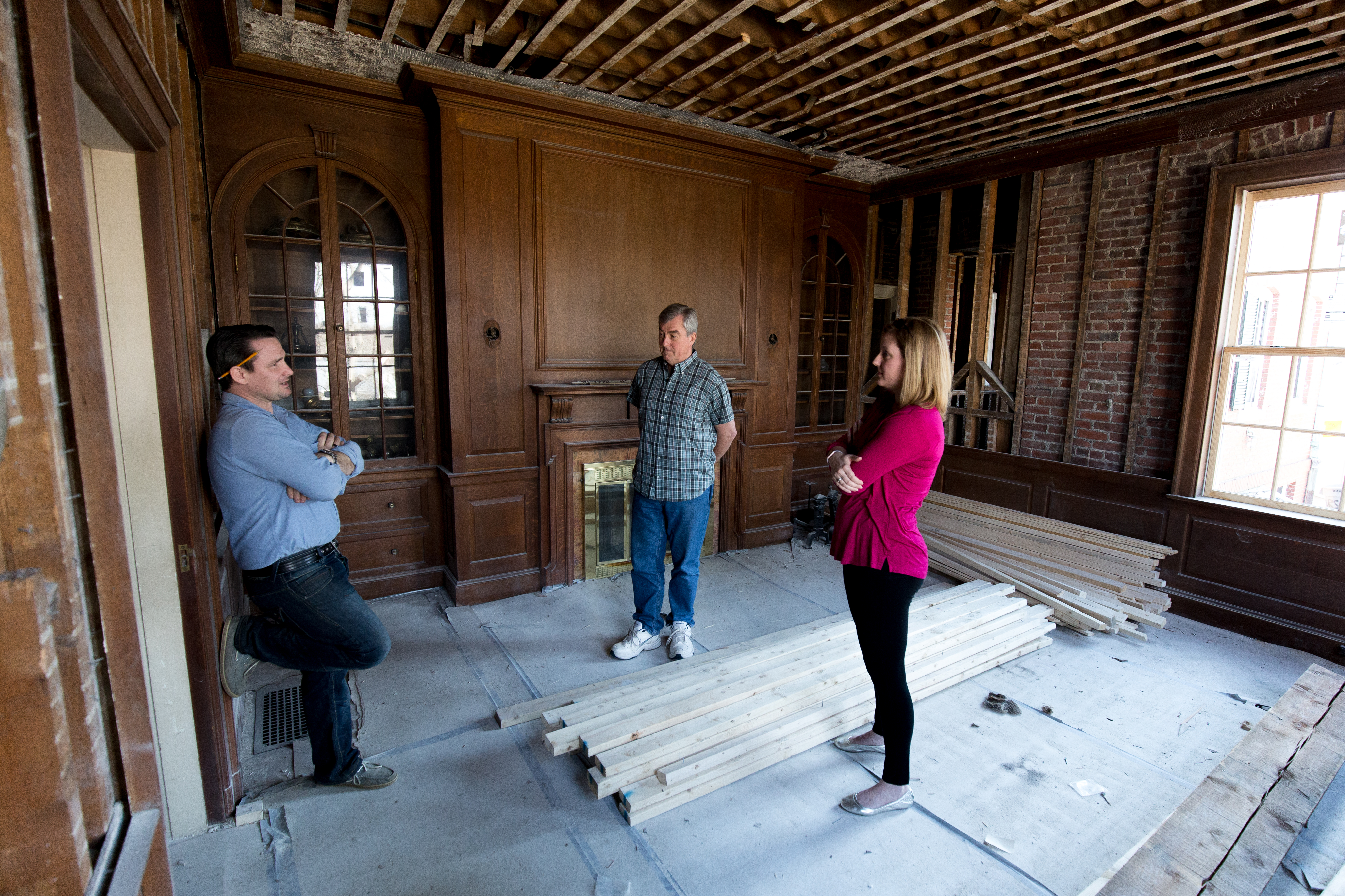 Builder Kevin Brett (left), Winchester Historical Commission member Jack LeMenager, and commission chair Heather von Mering tour a 1914 house being renovated at 7 Grove St. in Winchester.