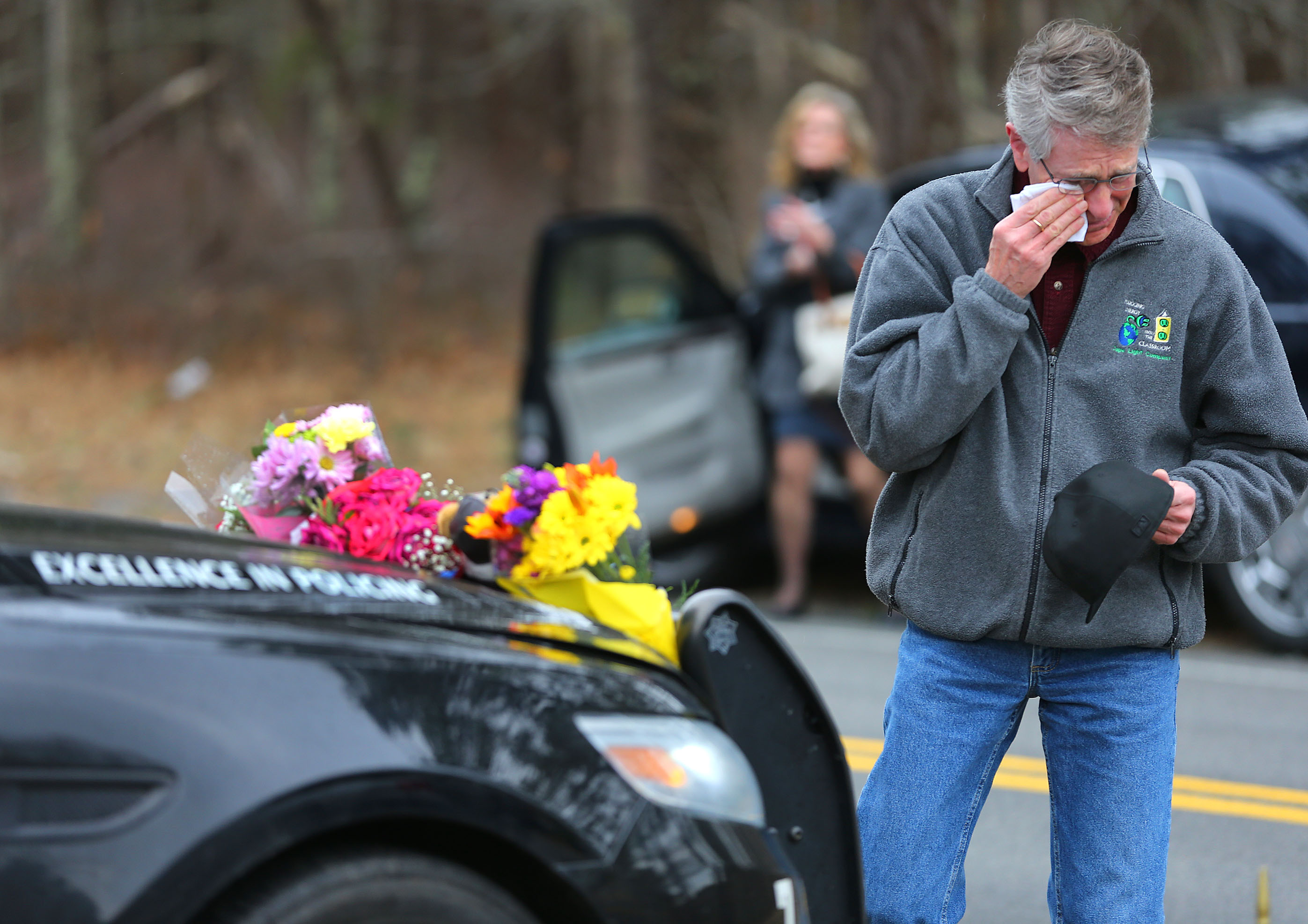 John Sinopoli cried and wiped a tear after he left off a bouquet of flowers on the cruiser belonging to slain officer Sean Gannon.