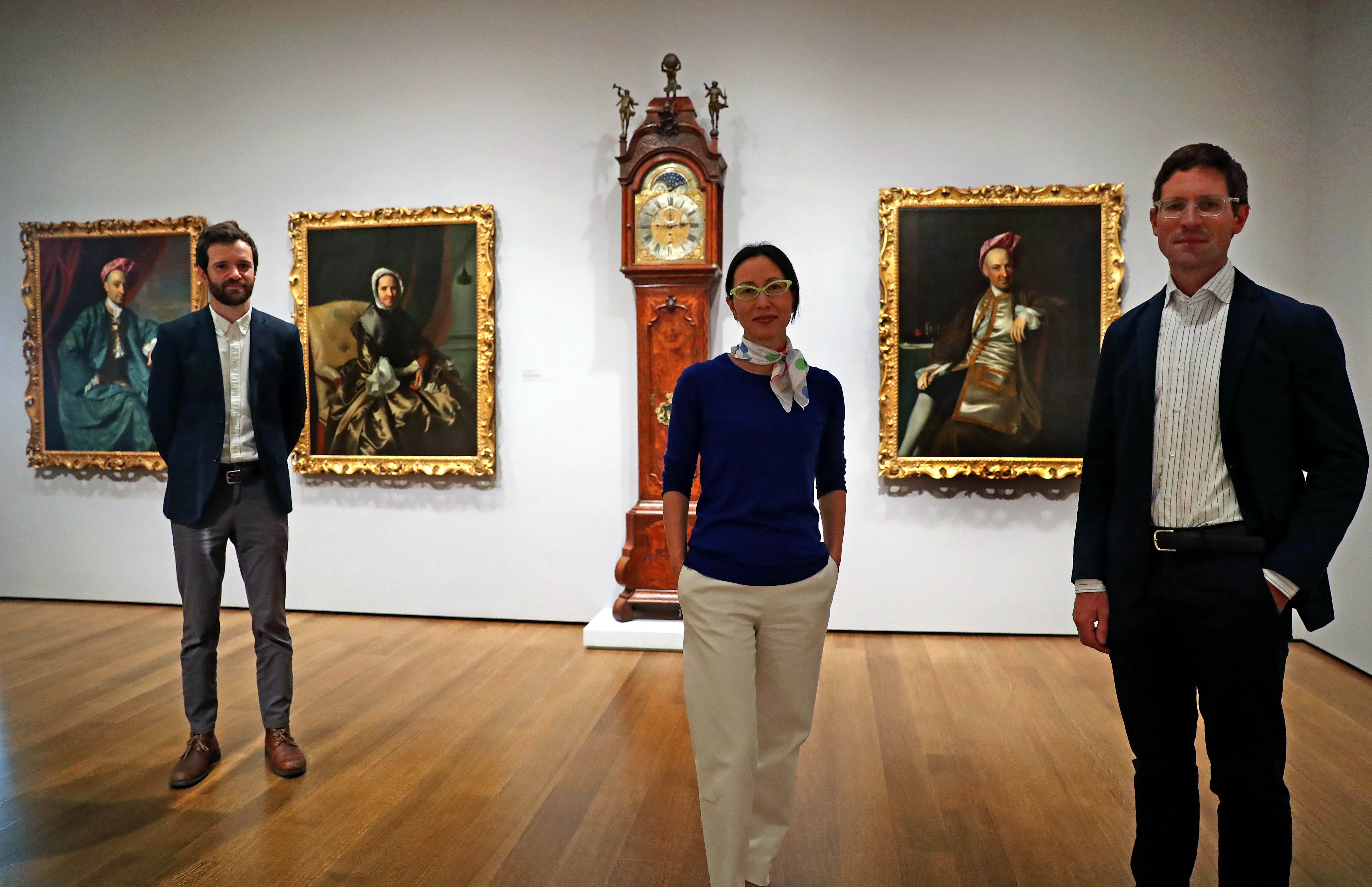 From left to right: Oliver Wunsch, former Maher curatorial fellow of American art; chief curator Soyoung Lee; and Ethan Lasser, the Harvard museums’ head of European and American art, posed with several Boylston family portraits by John Singleton Copley.