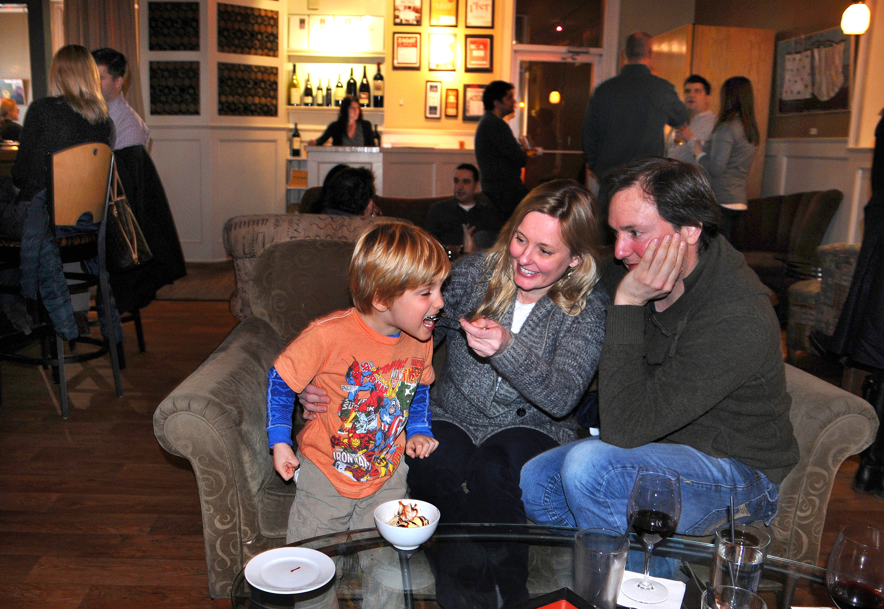 Frans Weterrings, 4, welcomes the hand that feeds him ice cream in the lounge area at Zebra’s Bistro and Wine Bar in Medfield. Parents Tiffany Kinder-Weterrings and Frans came prepared to enjoy their outing.