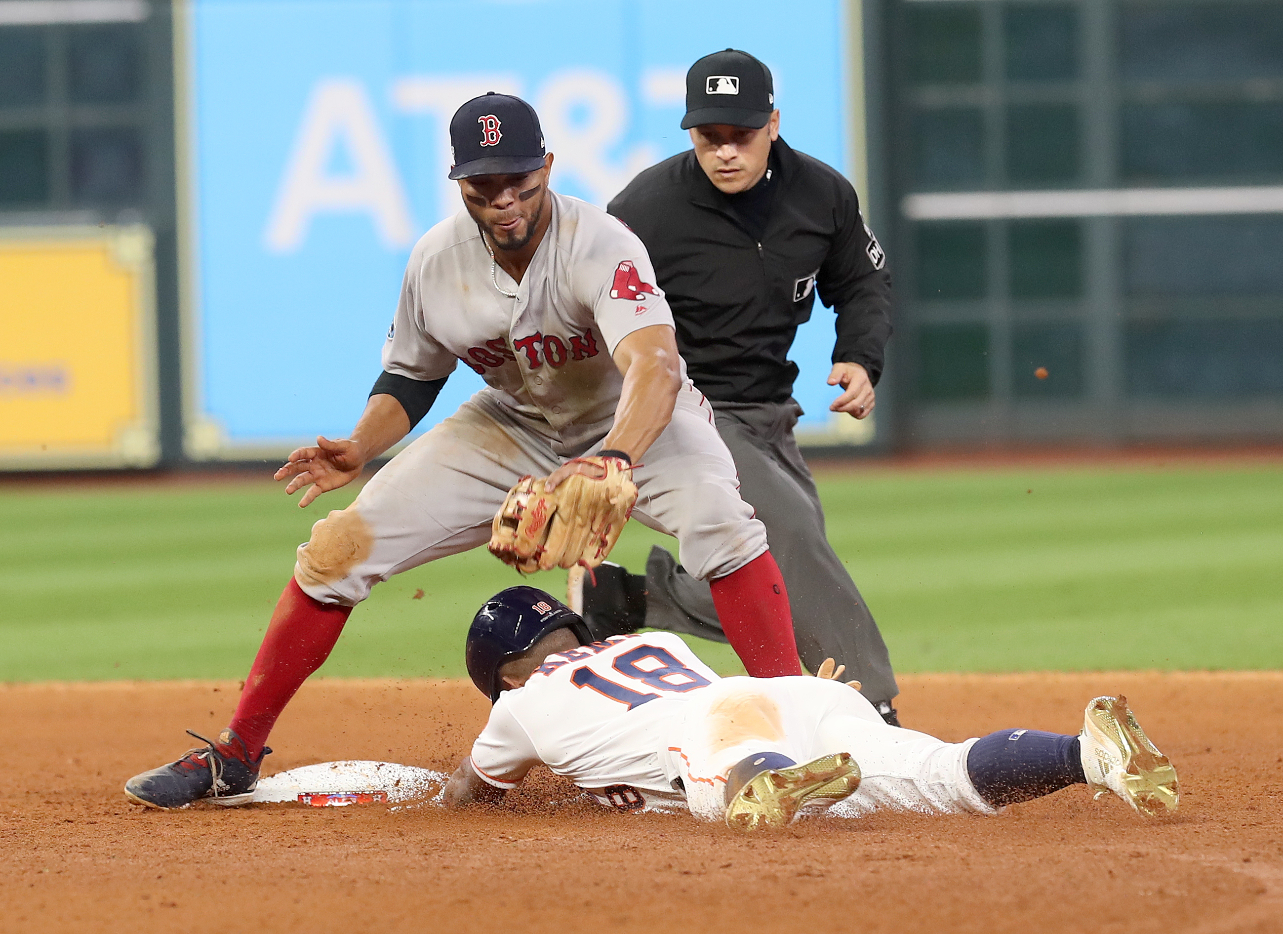 Xander Bogaerts slaps the tag on Houston’s Tony Kemp after fielding a perfect strike from Mookie Betts.