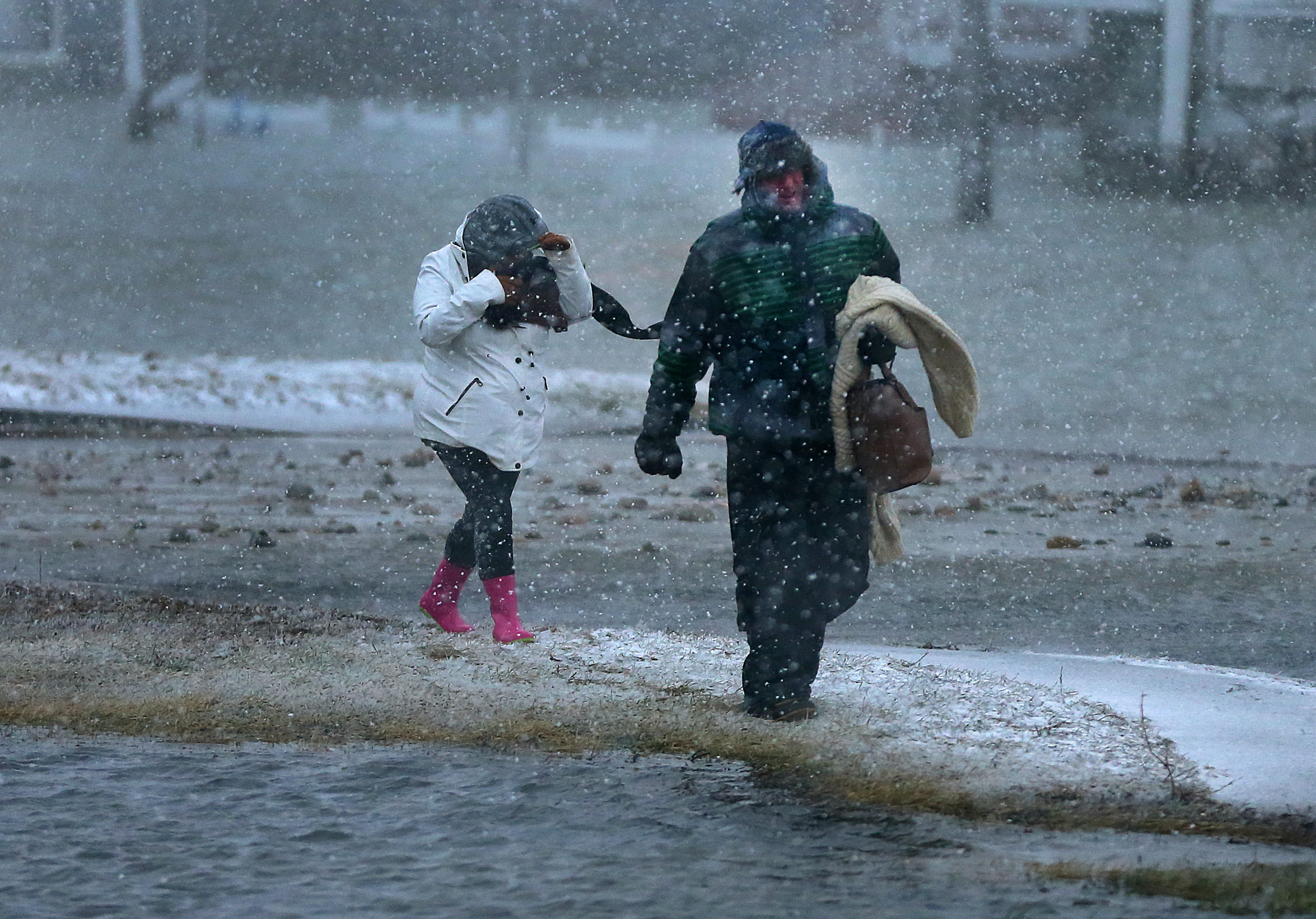 Two residents who did not want to spend the night in their home in the flooded Brant Rock section of Marshfield walked through the streets.