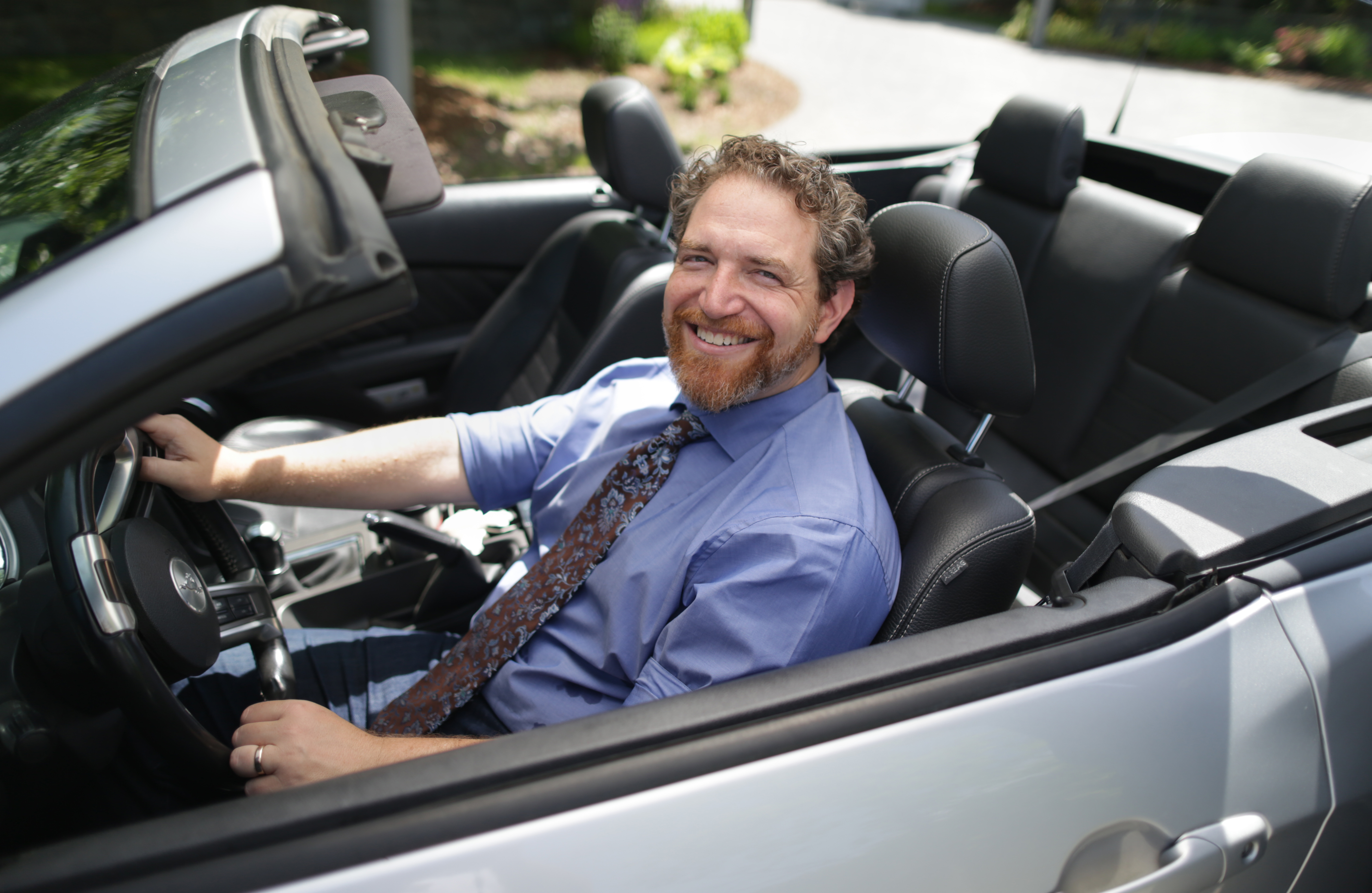Rabbi Michael Rothbaum in his Ford Mustang Convertable.